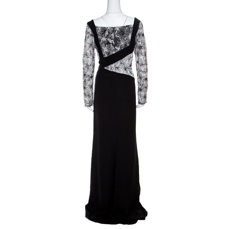 A sophisticated look comes with this Tadashi Shoji gown that is all set to slay the crowds. Blossoming with floral embroidery on the long sleeves and bodice, it is crafted with an asymmetric neckline and black panels to make you look extraordinary