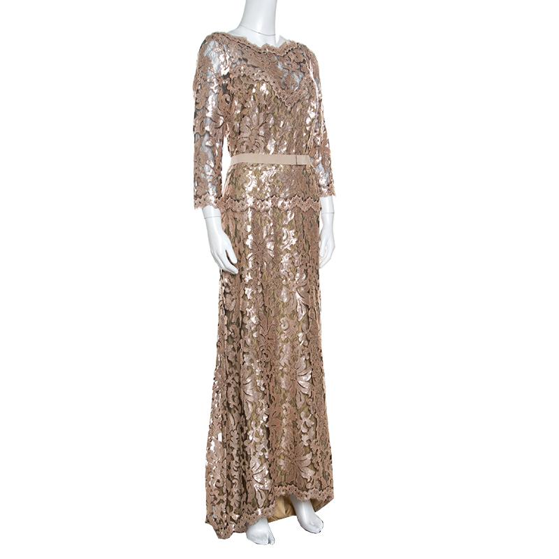 A true tribute to the beauty of a woman's body, this Tadashi Shoji gown is brilliant in a way that will make everyone halt. Designed with long sleeves, it has a luscious lace overlay enhanced with sequins and a belted waistline for a gorgeous shape.
