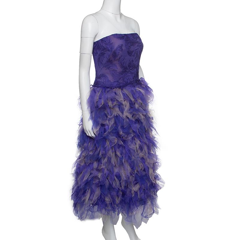 Resplendent and ravishing, this purple and beige dress from Tadashi Shoji is sure to set hearts racing. The stunning strapless dress is made of a blend of fabrics and features a tulle embroidered silhouette, faux feathers and a zip closure at the