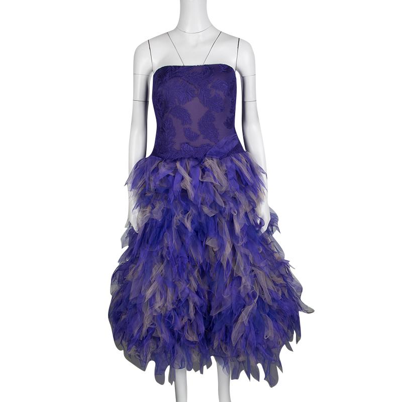 Tadashi Shoji's Fall-Winter collection of 2015 was all about floating, aerial dresses with a sense of flight. A part of the collection, this purple strapless dress comes with an embroidered bodice and beautifully feathered, tulle bottom. This