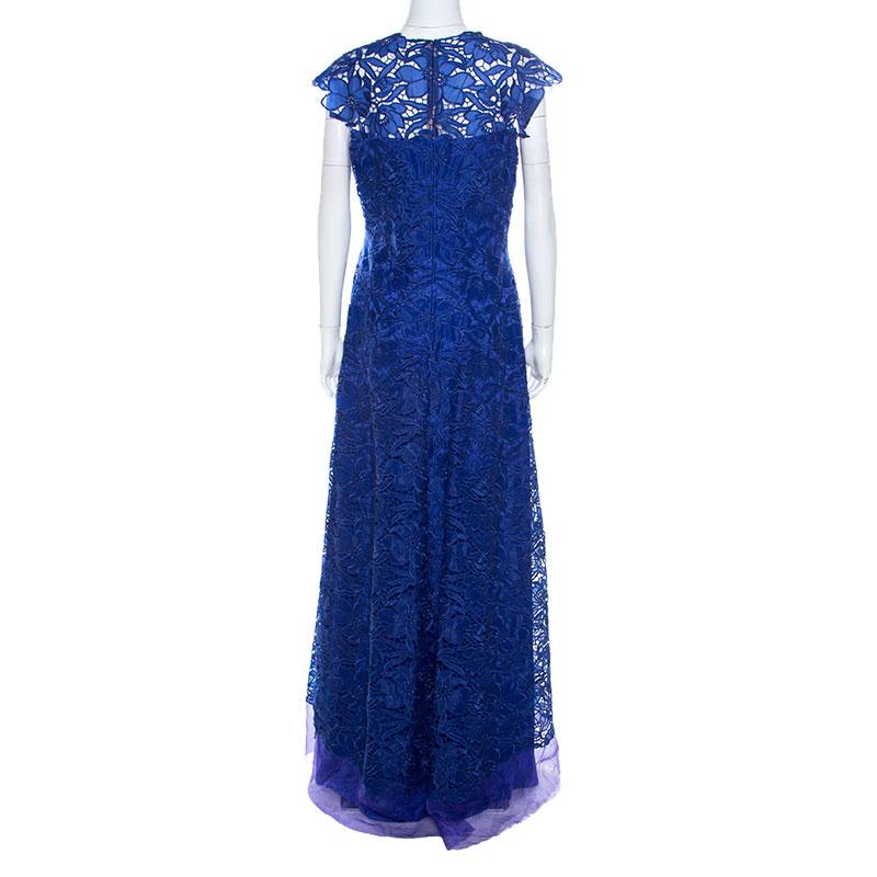 This Tadashi Shoji gown takes the brand's signature image to new heights. Adorned in royal blue, it features a feminine lace overlay. It has a lovely silhouette complemented with a floor-grazing hemline and cap sleeves.

Includes: Price Tag