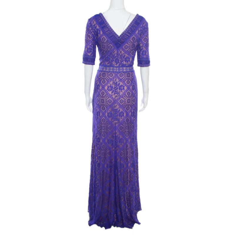 Tadashi Shoji design their elegant evening wears with subtle hints of glamor. This pretty purple, short sleeved gown is styled with floral lacework all over, a plunging neckline and a zip closure at the rear to give you a flattering shape. A part of