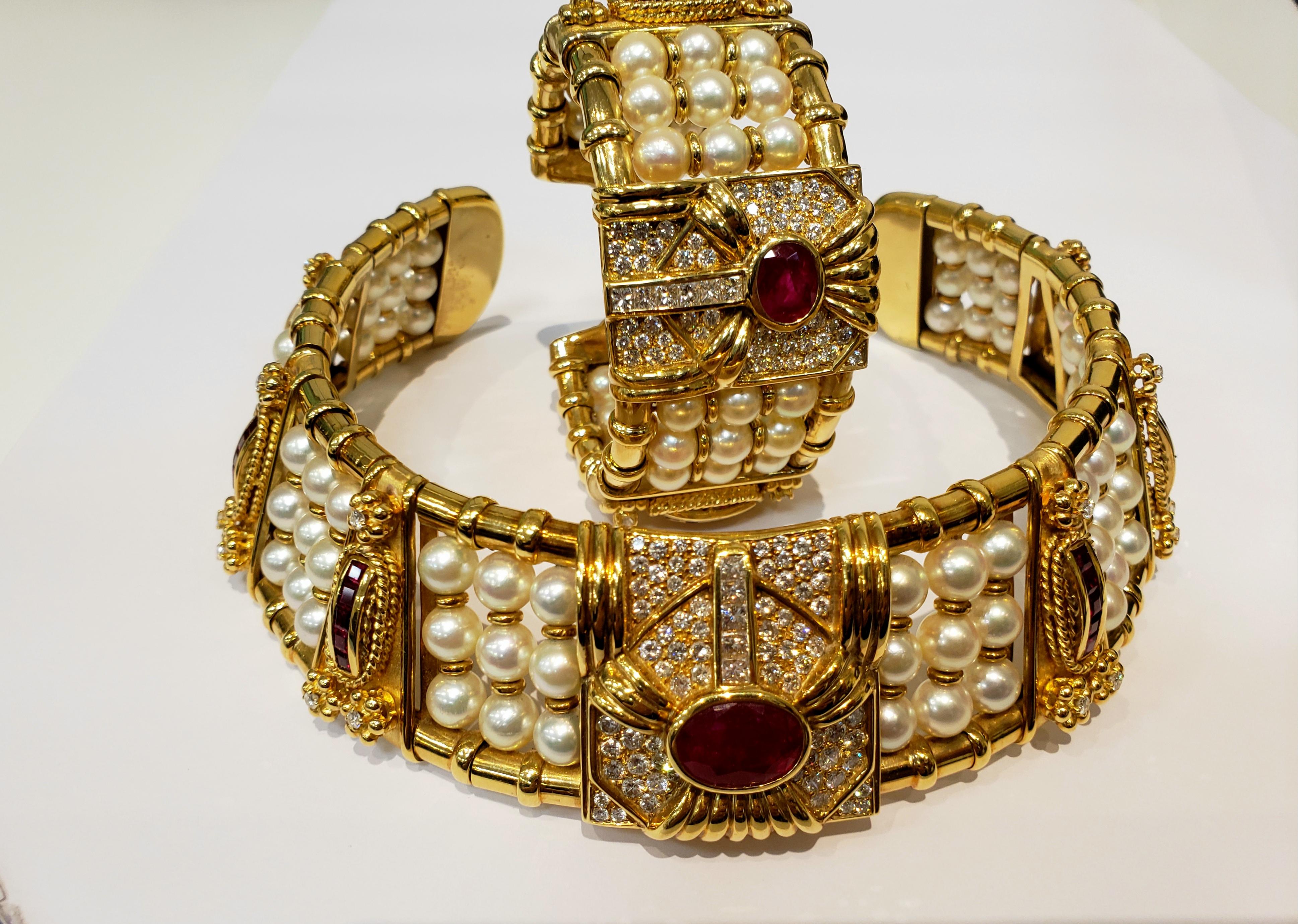 This is a One Of a Kind Tadini Choker & Cuff Bracelet. Choker has 8 Sections, Each With 3 Rows Of 3, 7 Millimeter Pearls.
There Are 6 Gold Sections, With a Vertical Row Of 5 Square Rubies, With 3 Diamond Accents. Center Of Collar Has a Large Diamond