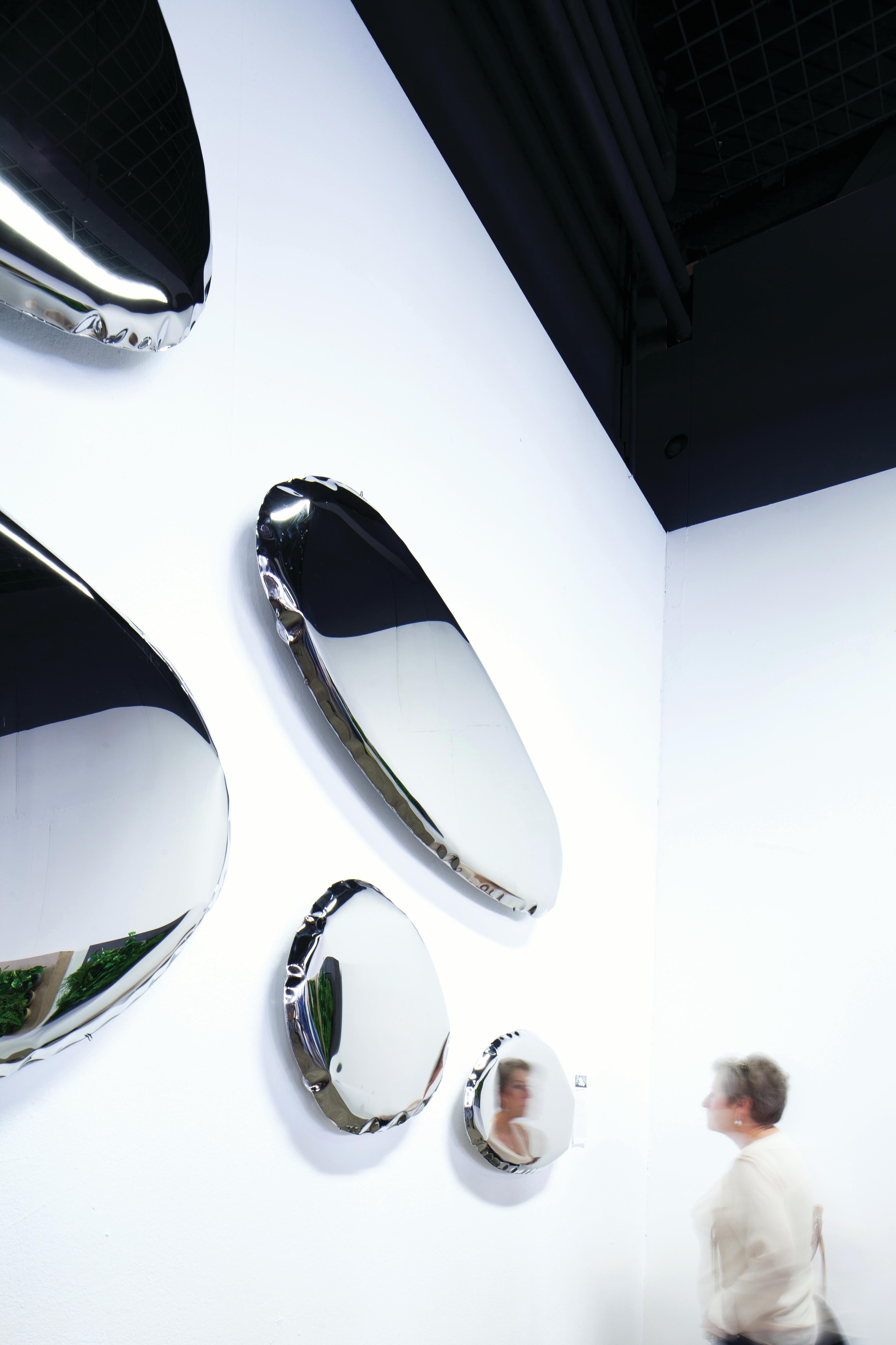 Tafla 06, sculptural wall mirror, Zieta

Title: Tafla 06

Material: Polished stainless steel

Measures: 
H 23.63 in. x W 19.69 in. x D 2.37 in.
H 60 cm x W 50 cm x D 6 cm

Tafla O series is characterized by smooth, optically light shapes