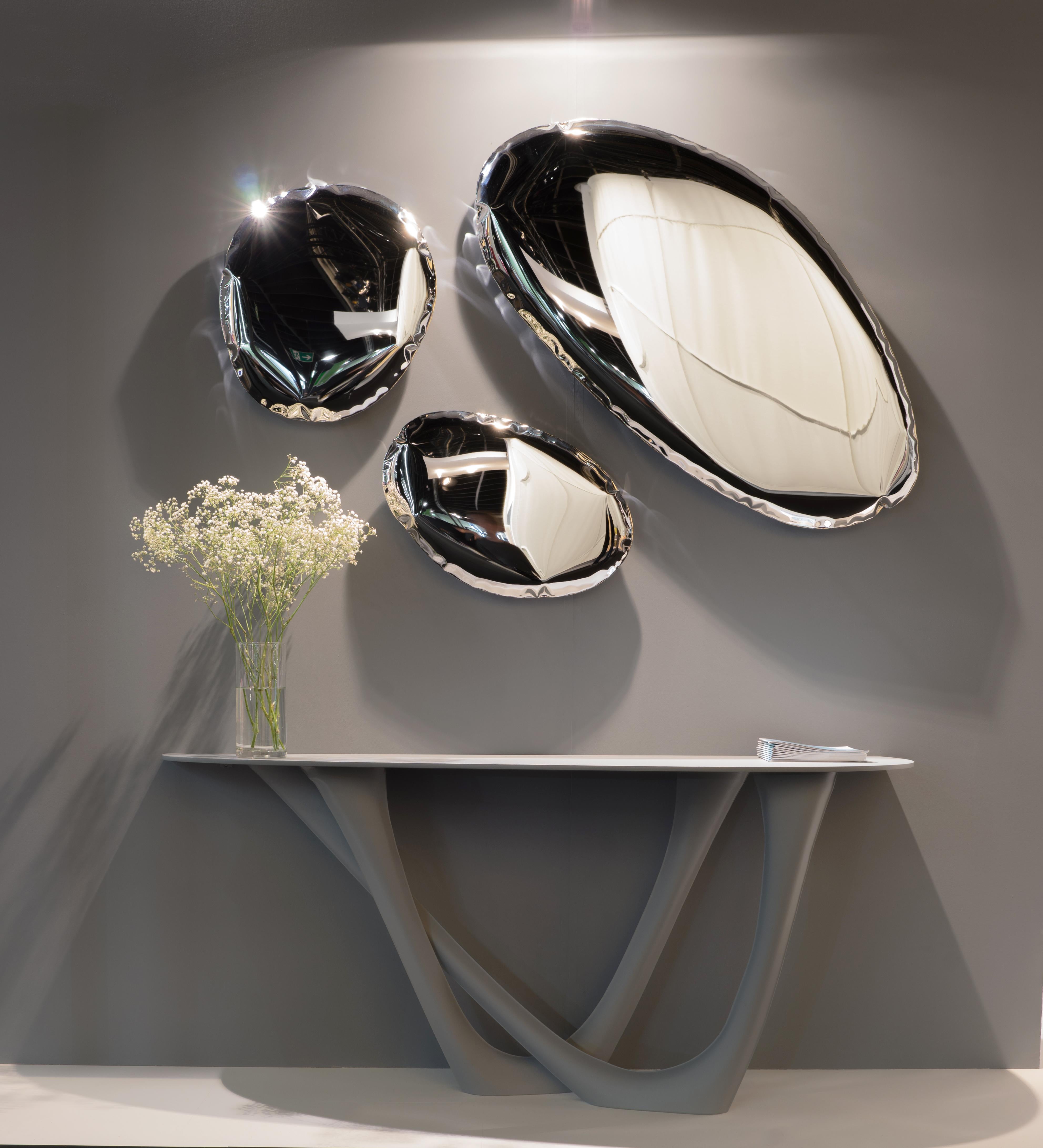 Tafla Q5 - Sculptural wall mirror - Zieta

Title: Tafla Q5

Material: polished stainless steel

Measures: 
H 2.37 in. x Dm 14.18 in.
H 6 cm x Dm 36 cm

Mirrors from Q series are simple, pure, well known geometric forms of sophisticated
