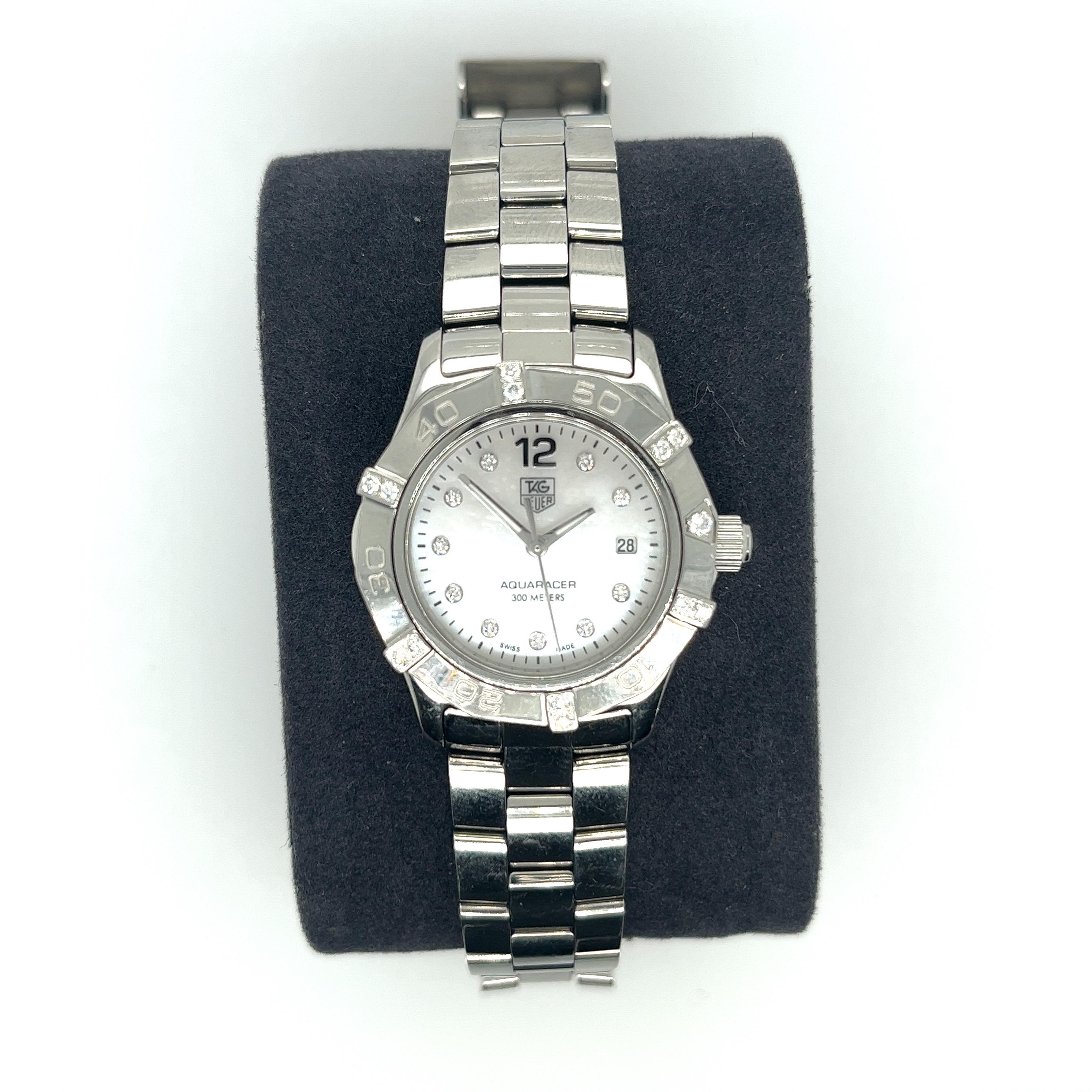 This stunning TAG Heuer Aquaracer Lady Ref LG9075/WAF141G is crafted with a steel case, mother of pearl Dial and diamond numeral markers. The case is set with diamonds at certain spots around it and is moveable. The bracelet fits up to a 6