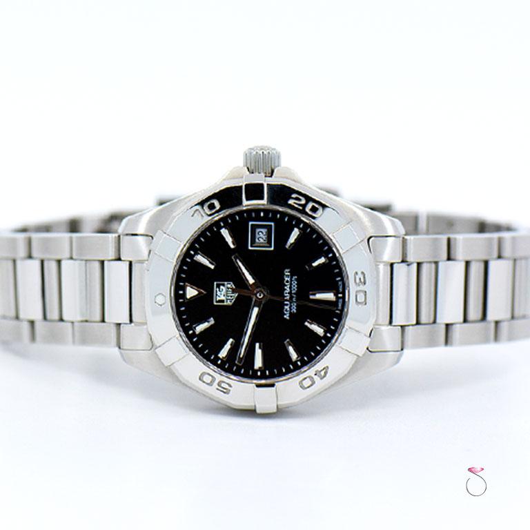 Tag Heuer Aquaracer stainless steel ladies watch ref. WAY1410. This beautiful watch features a 27 mm stainless steel case that houses the Tag Heuer quartz movement and has a screw dowm crown. The watch has a steel rotating bezel and a black dial.