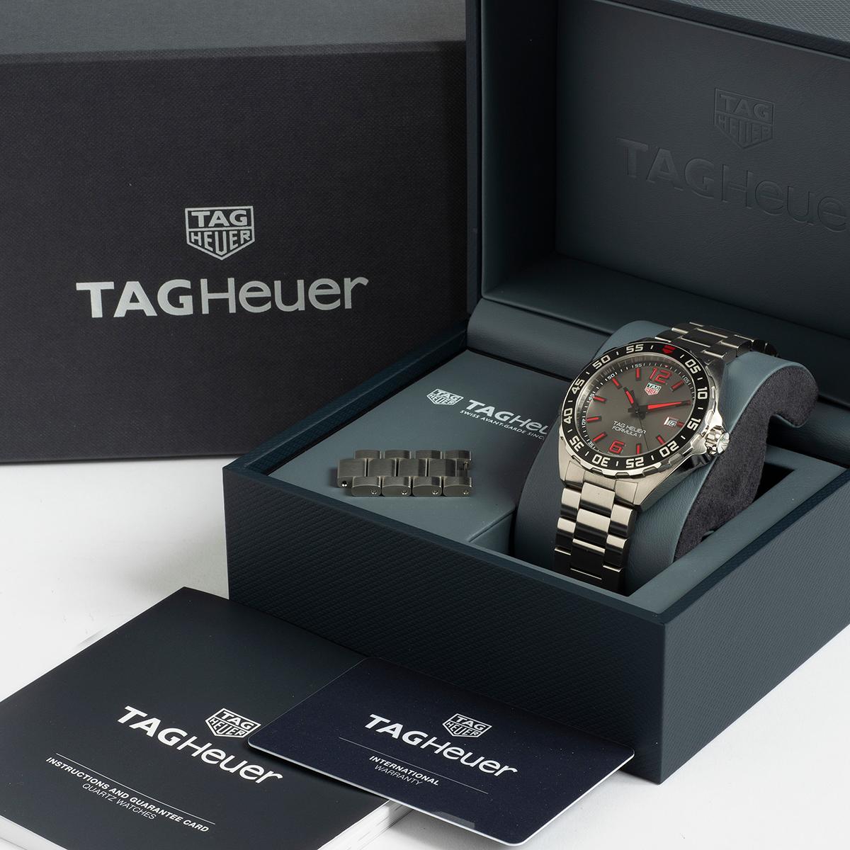 Our rare and discontinued Tag Heuer Formula 1 reference WAZ1018 with quartz movement features a stainless steel 43mm case with very attractive graphite and red dial , stainless steel bracelet. A instantly recognisable sports watch, this example