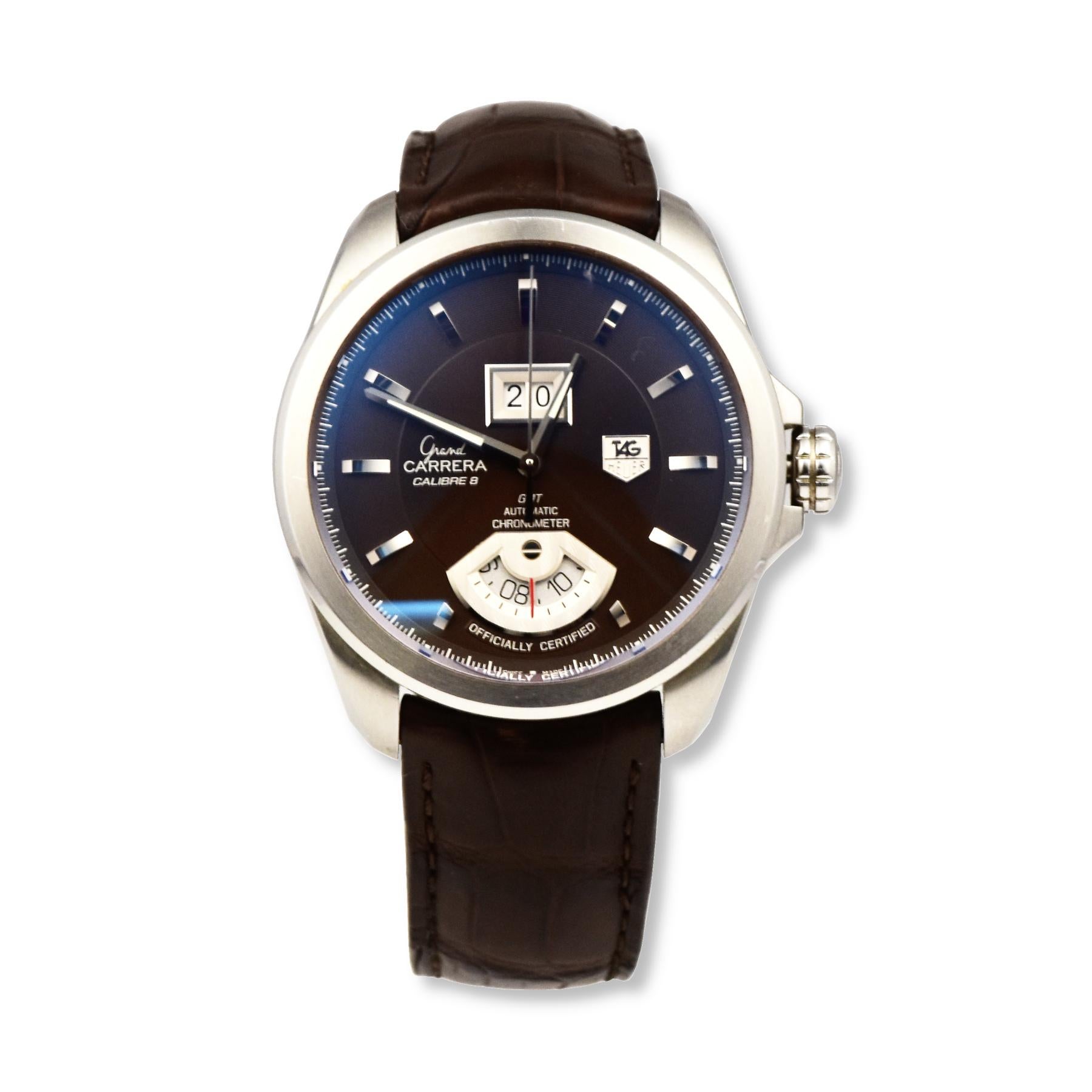 This Tag Heuer Grand Carrera Calibre 8 has a Silver-tone stainless steel case with a brown crocodile leather strap. Fixed silver-tone stainless steel bezel. Brown dial with silver-tone hands and index hour markers. Minute markers around the outer
