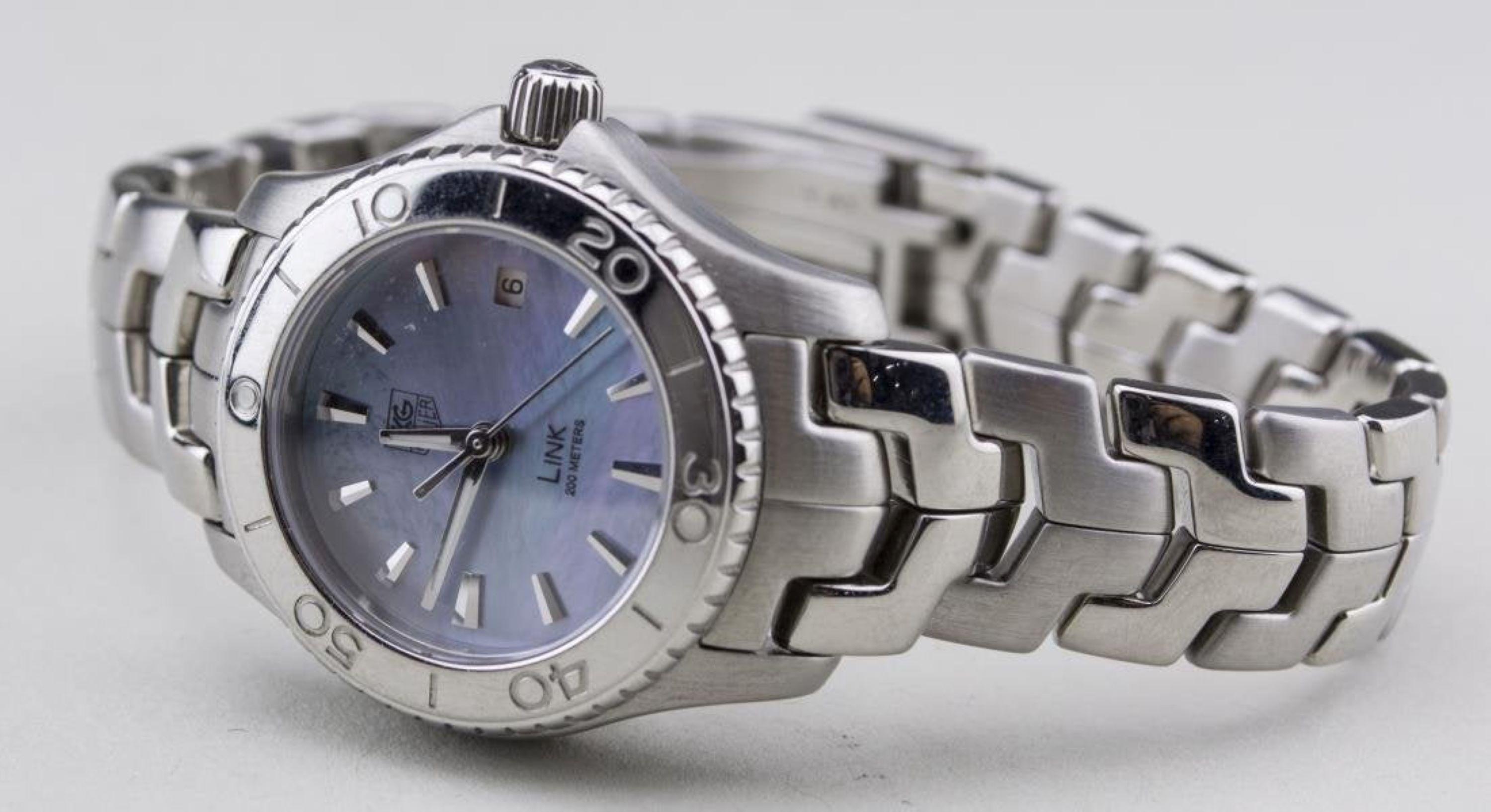 Blue mother of pearl dial with baton hours, date aperture, stainless steel band.