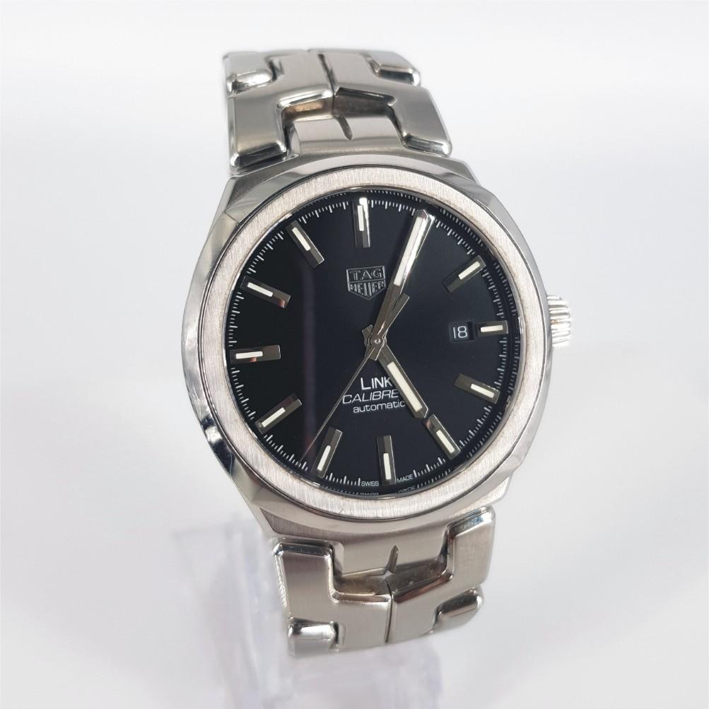 Tag Heuer Link Calibre 5 – Automatic in Excellent condition. 
Serial Number: RQM3942 
Model Number: WBC2110
Year: 2022
Stainless Steel Case measuring 40mm with a Black Dial & Stainless Steel Strap measuring 51mm with 4 extra links.
