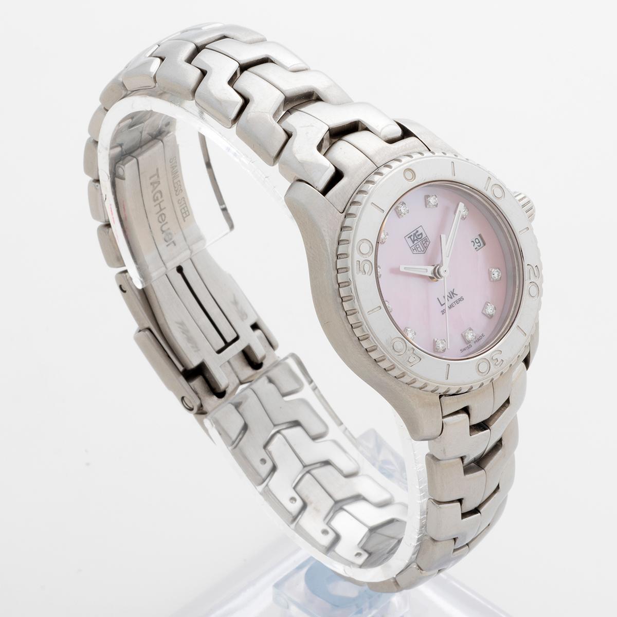 Our very attractive ladies Tag Heuer Link quartz date , reference WJ131-C1, features a 28mm stainless steel case with polished rotating bezel, factory pink mother of pearl dial set with eleven fine quality diamonds, and stainless steel bracelet,