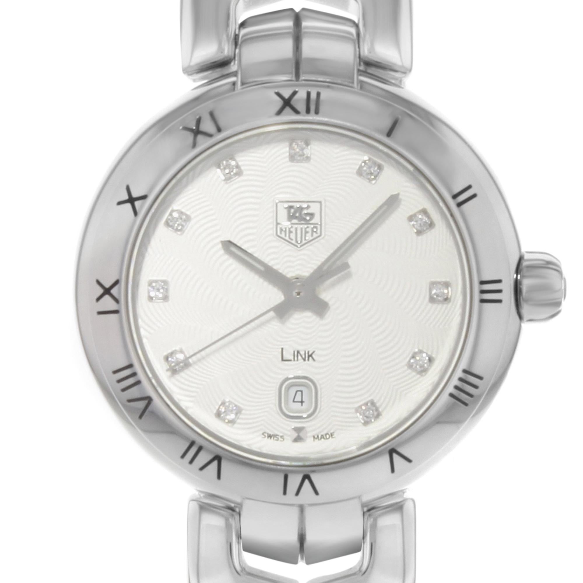 This display model TAG Heuer Link WAT1411.FC6316  is a beautiful Womens timepiece that is powered by a quartz movement which is cased in a stainless steel case. It has a round shape face, date dial and has hand diamonds style markers. It is