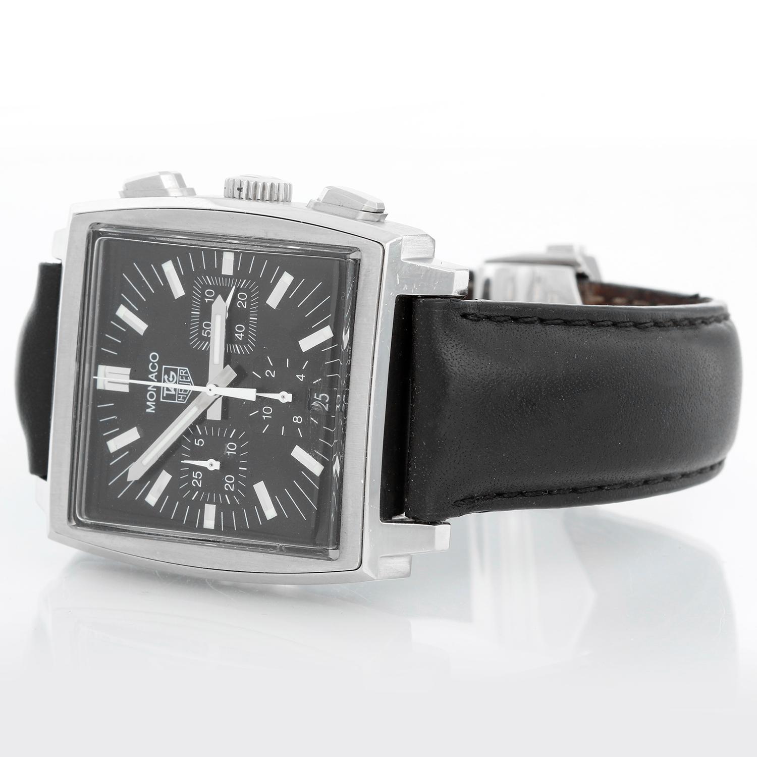 Tag Heuer Monaco Chronograph Men's CW2111 Watch - Automatic winding. Stainless steel case ( 38 mm ). Black dial with index hour markers. Black leather strap with stainless steel deployant clasp. Pre-owned with Tag box and book
