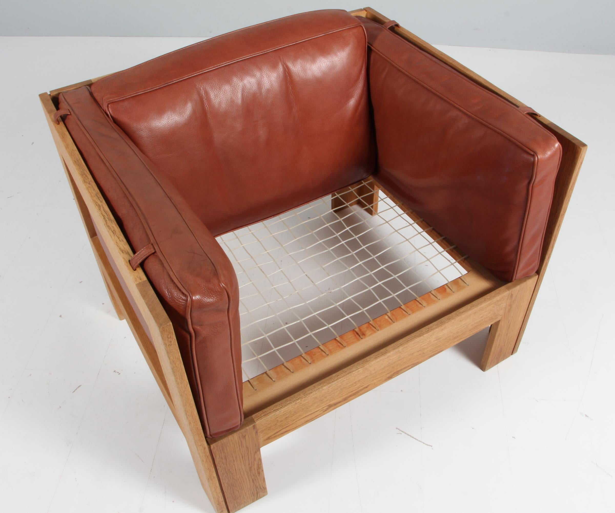 Danish Tage Poulsen lounge chair, in Oak and Patinated Leather, Denmark, 1970s
