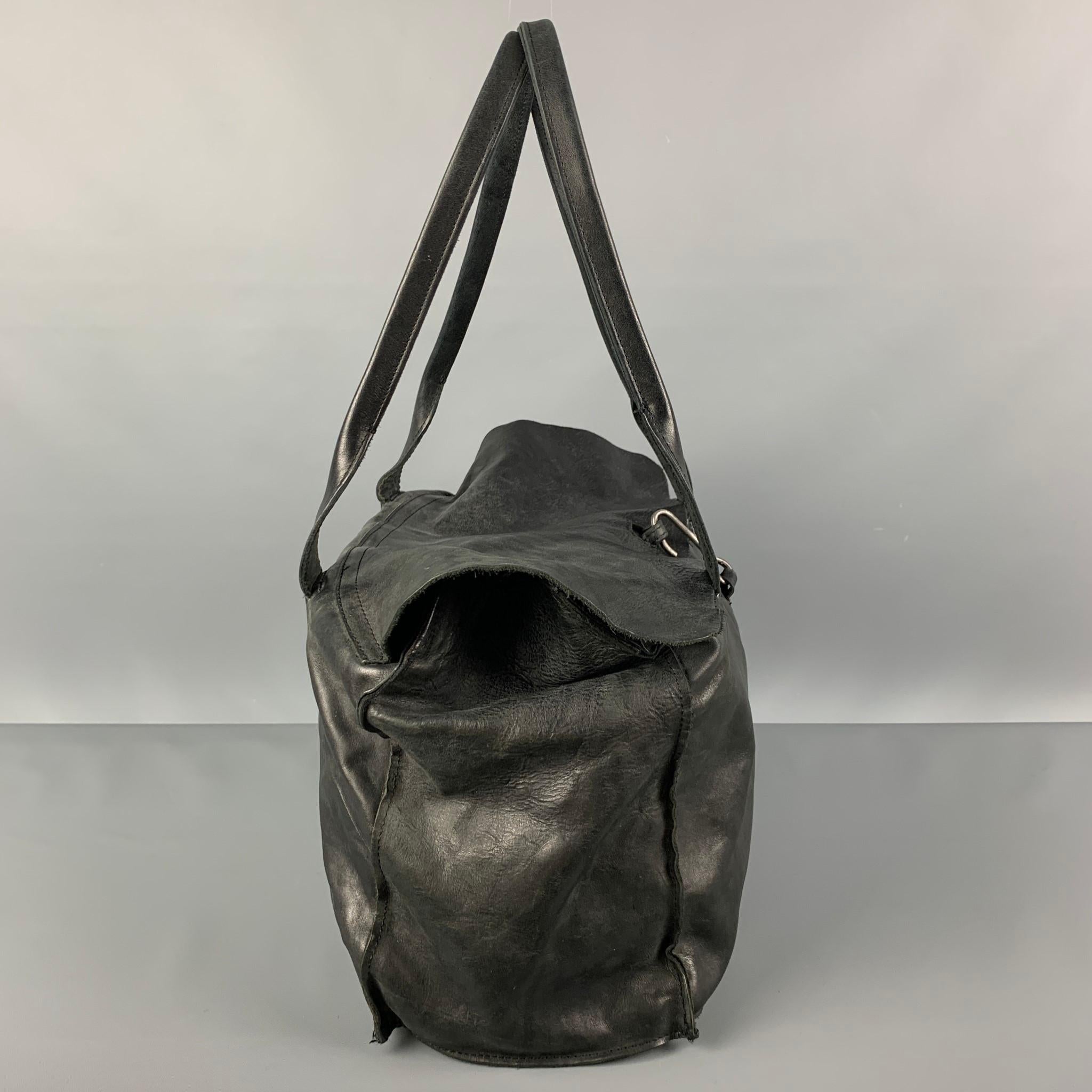 TAGLIOVIVO 'Doctor' bag comes in a black horsehide leather featuring top handles, inner pocket, linen lining, and a hook & eye closure. Made in Italy.

Very Good Pre-Owned Condition.
Original Retail Price: $1,040.00

Measurements:

Length: 15.5