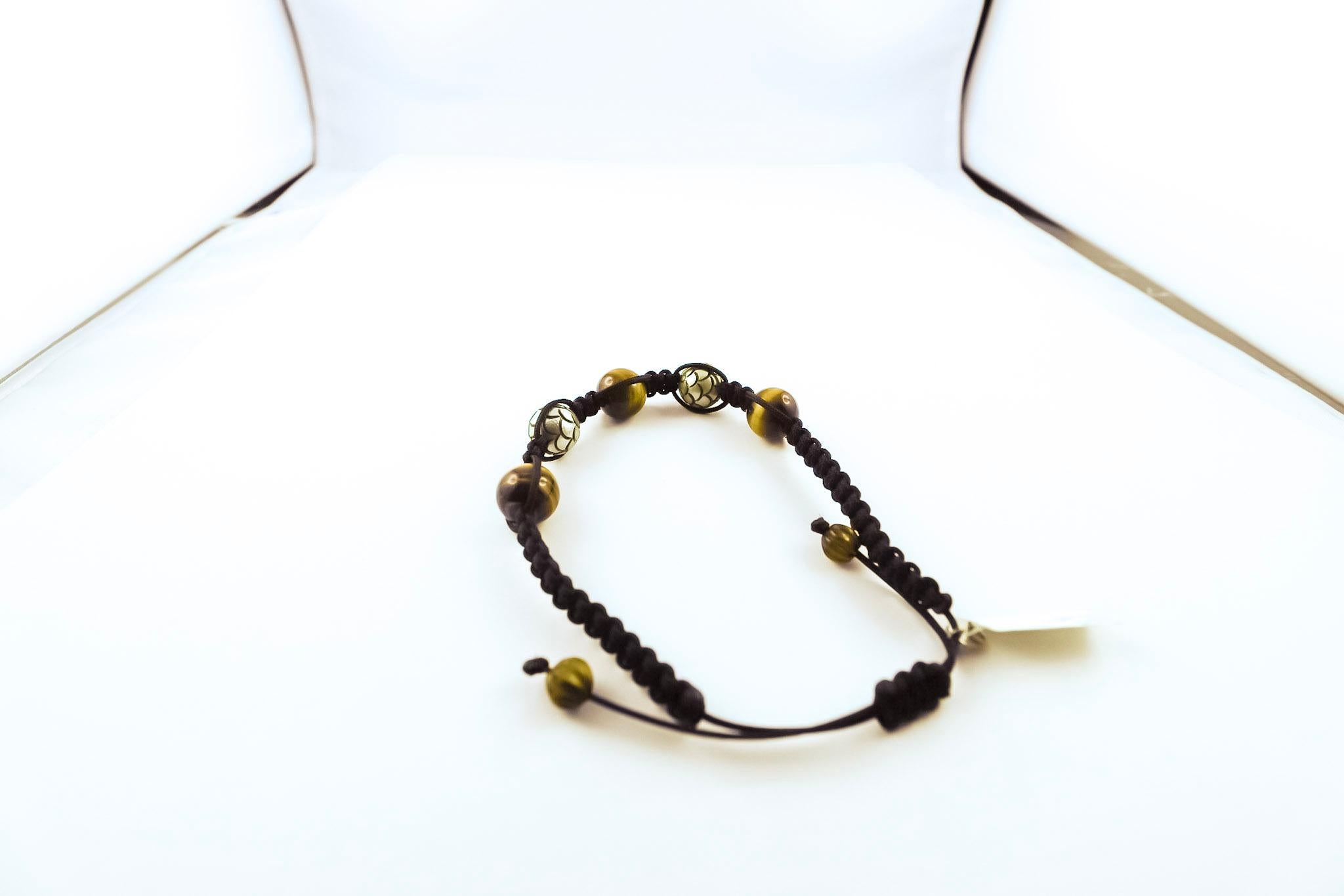 Upgrade your everyday accessories with this lovely versatile handmade bracelet, robustly threaded with black makramee.
It offers beautifully carved Tahiti pearls, tiger eyes, finished with white gold 18K.
Suited to any occasion and any attire, we