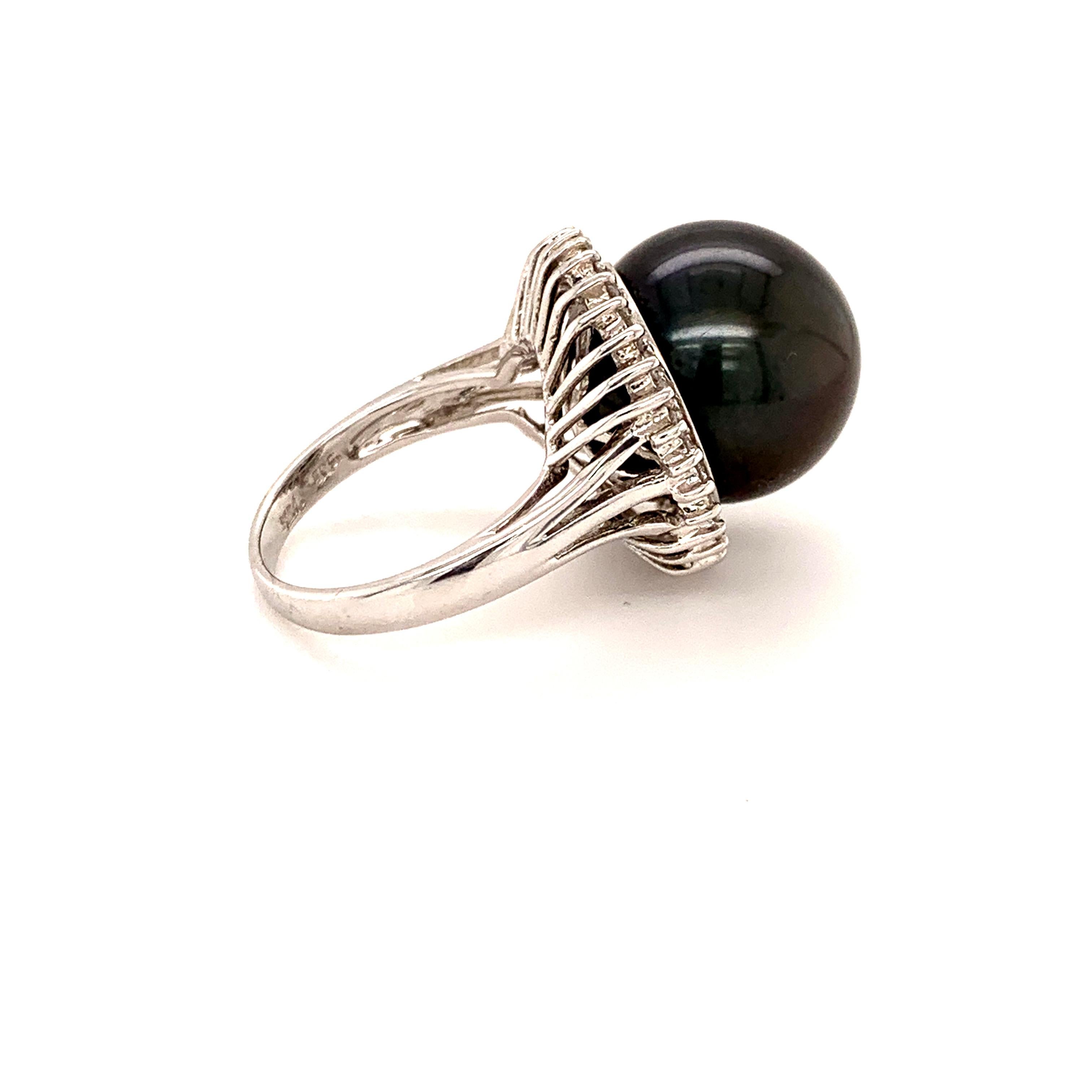 Bold Tahitian pearl diamond cocktail ring. Very good lustre, black with rose, silver overtone, 14.5mm round Tahitian pearl mounted in high profile, accented with round brilliant cut diamonds. Handcrafted contemporary high polished design set in 14