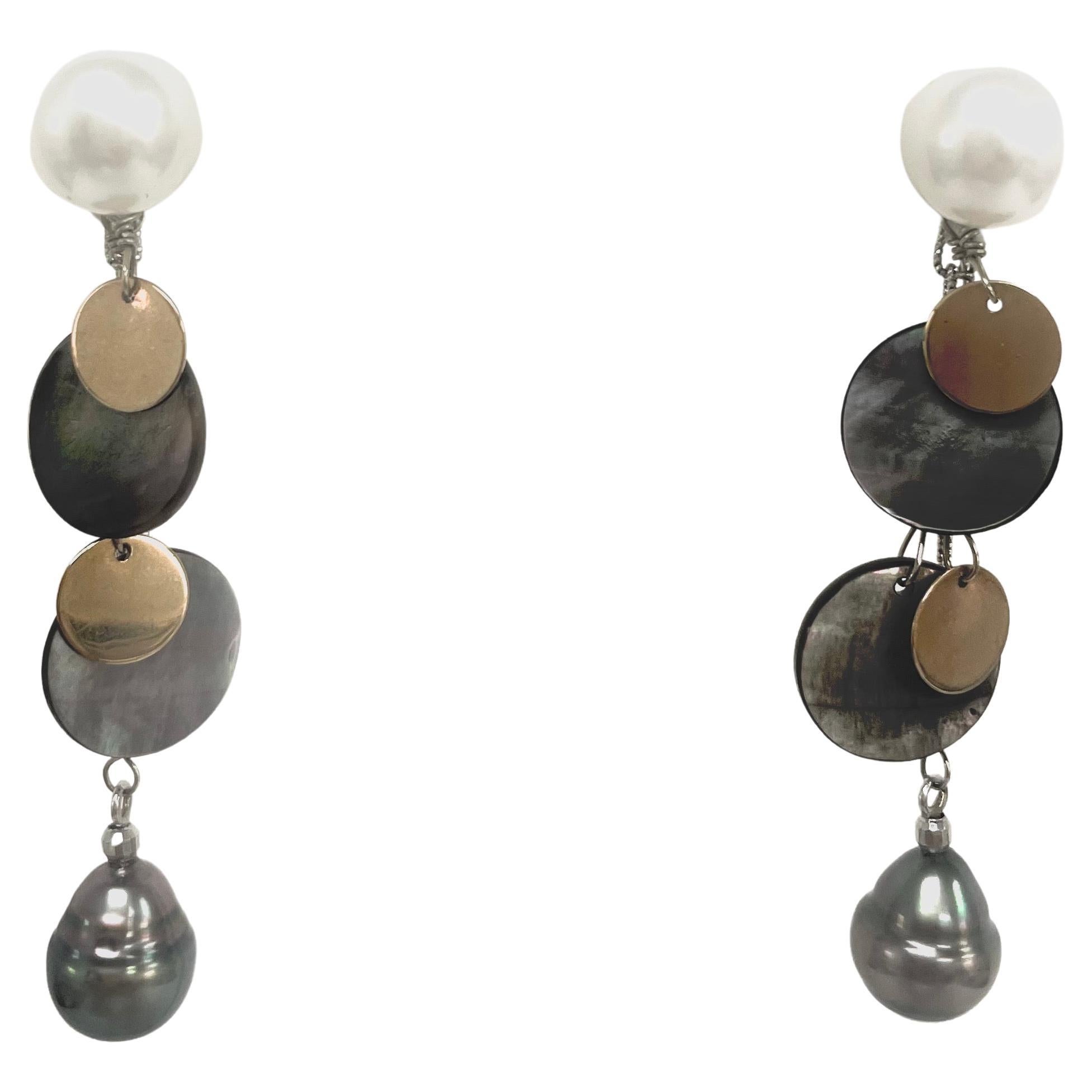 Description
Lovely, feminine combination of rare iridescent Tahitian Mother of Pearl with 14k yellow gold discs and black Tahitian pearl drops dangling from high quality white lustrous round freshwater pearl studs. Item # E1381
Check out matching