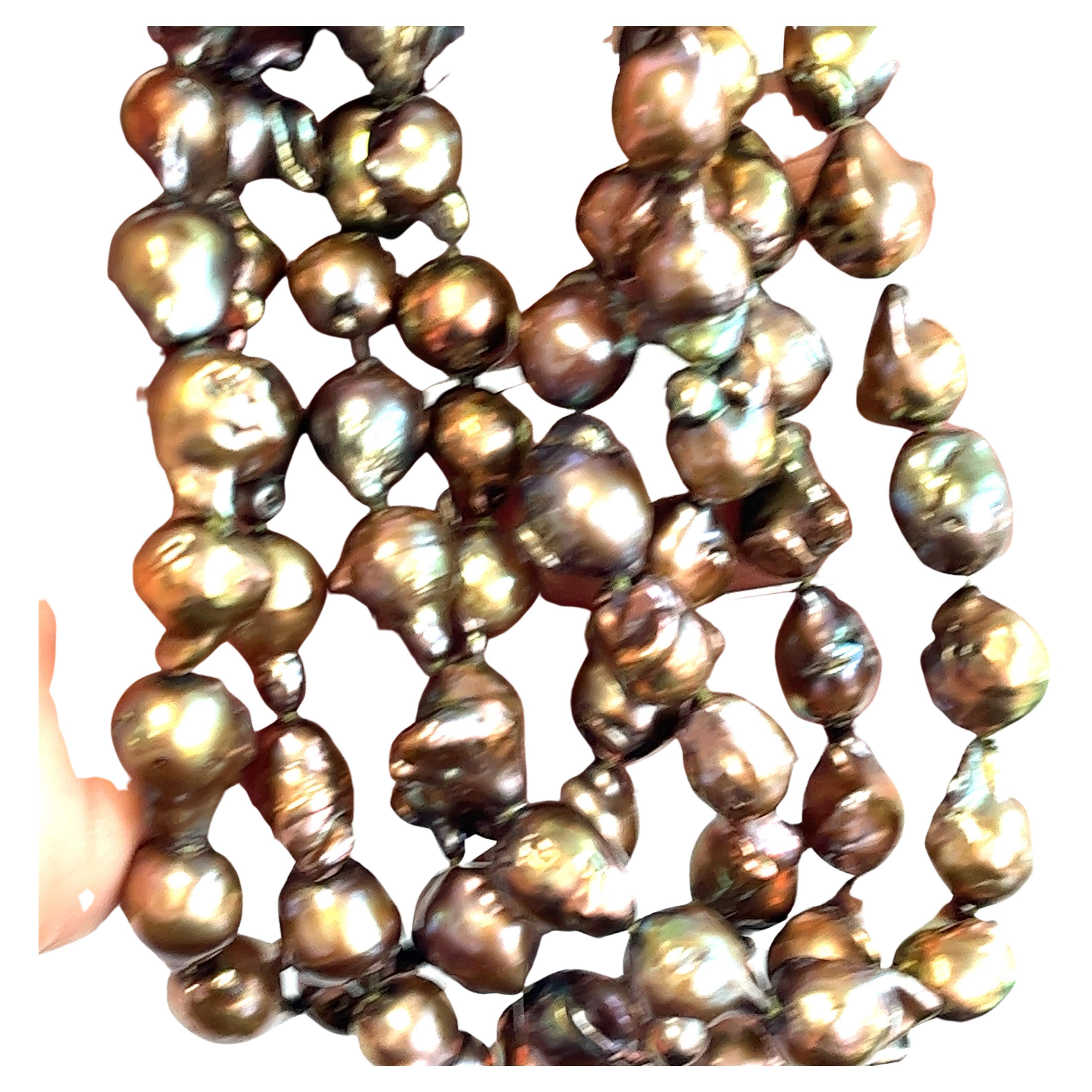 Discover the allure of the ocean with our Tahitian Baroque Pearl Necklace. This captivating masterpiece spans a luxurious 46 inches, adorned with 87 exceptional pearls, each averaging an impressive 12mm in size. Embrace the enchantment of nature's
