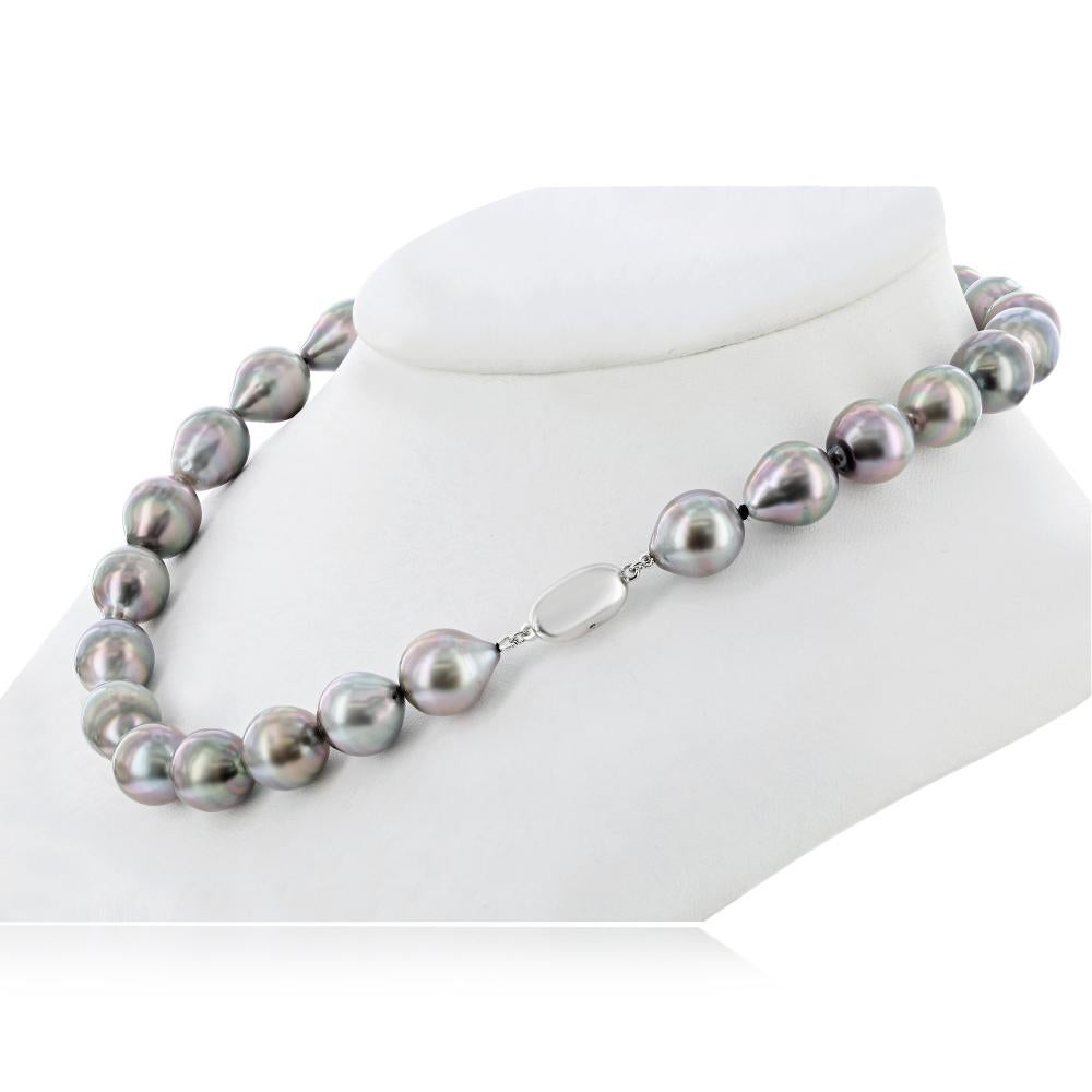 This natural color Tahitian Baroque pearl necklace features fine quality, high luster 12x13mm pearls. The necklace is strung to 18 inch length with a metal clasp. 
Featuring high quality, dark colored pearls with pink, blue, and green overtones,