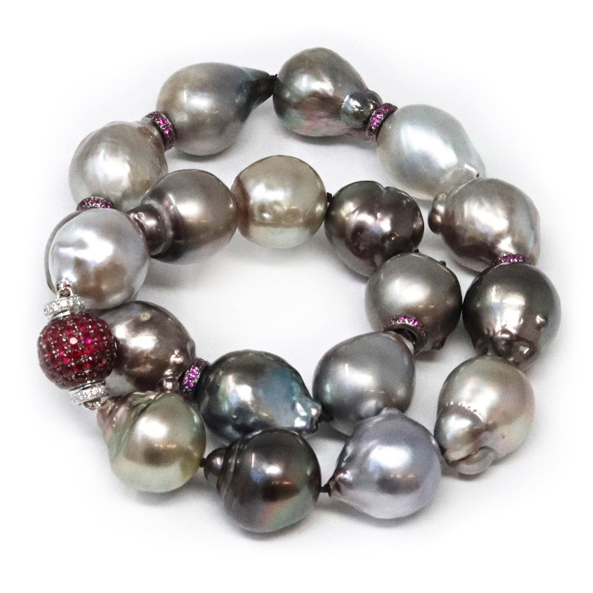 A striking and modern necklace featuring 19 Baroque AKA Free Form Tahitian pearls. The pearls are above average in size 14 to 17 millimeters. They display very good luster with a soft range of hues ranging from light pistachio to light grey. The
