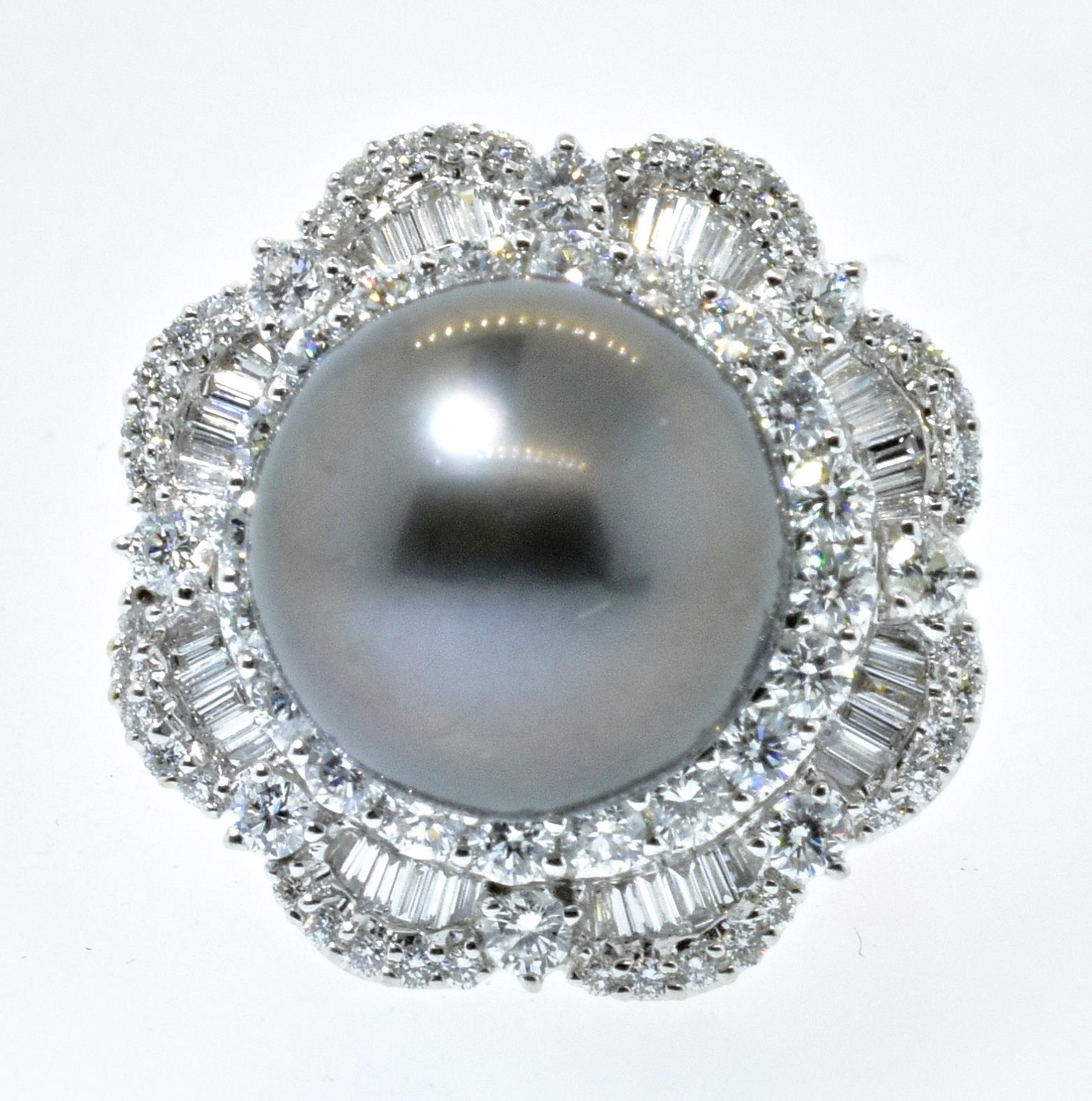 Tahitian pearl of 14.5 mm, with fine color, perfectly round, clean and with a  fine depth of nacre.  This 18K white gold ring has 4.5 cts., of very fine diamonds - all near colorless, G, and very slightly included, VS.  Well made with fine
