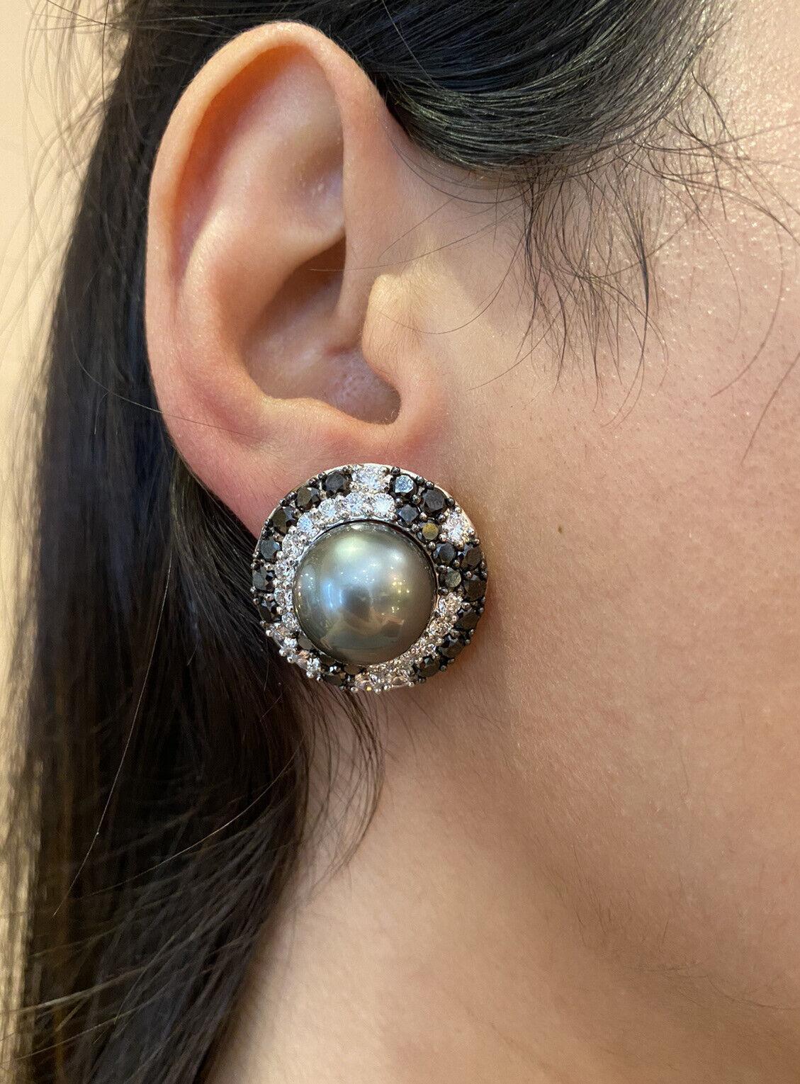 Tahitian Black Pearl Earrings with Black & White Diamonds in 18k White Gold

Large Diamond and Pearl Earrings features a Tahitian Black Pearl in the center, approximately 14mm in size, surrounded by White and Black Round Diamonds set in 18k White