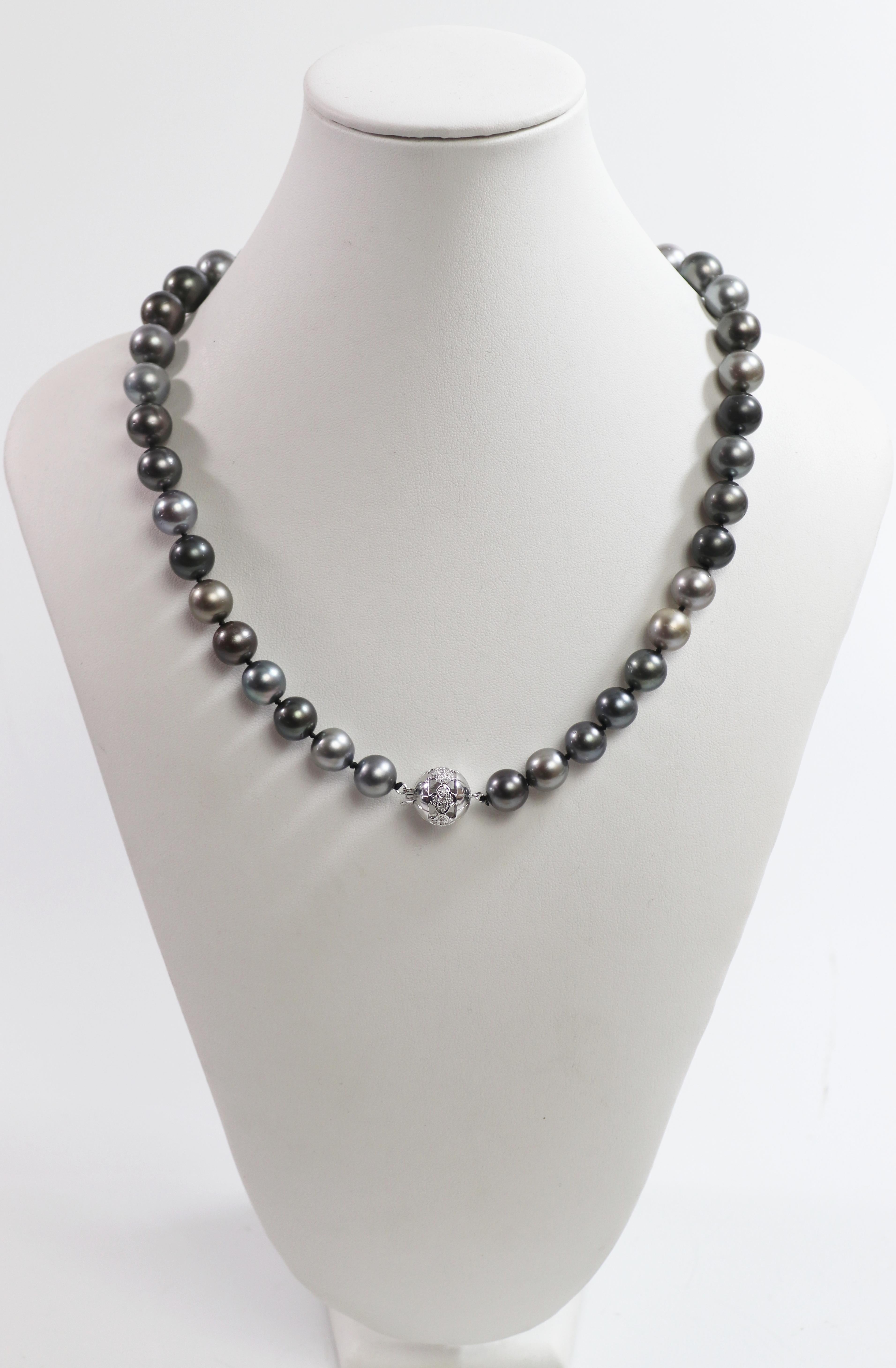 Composed of (40) mostly round, graduated Tahitian grey, black, silver and
grey cultured pearls, 14.5 mm to 10.5 mm, with fine silver to peacock
overtones, very good luster, minimal blemishes, completed by a 14 mm,
18k white gold flower motif ball
