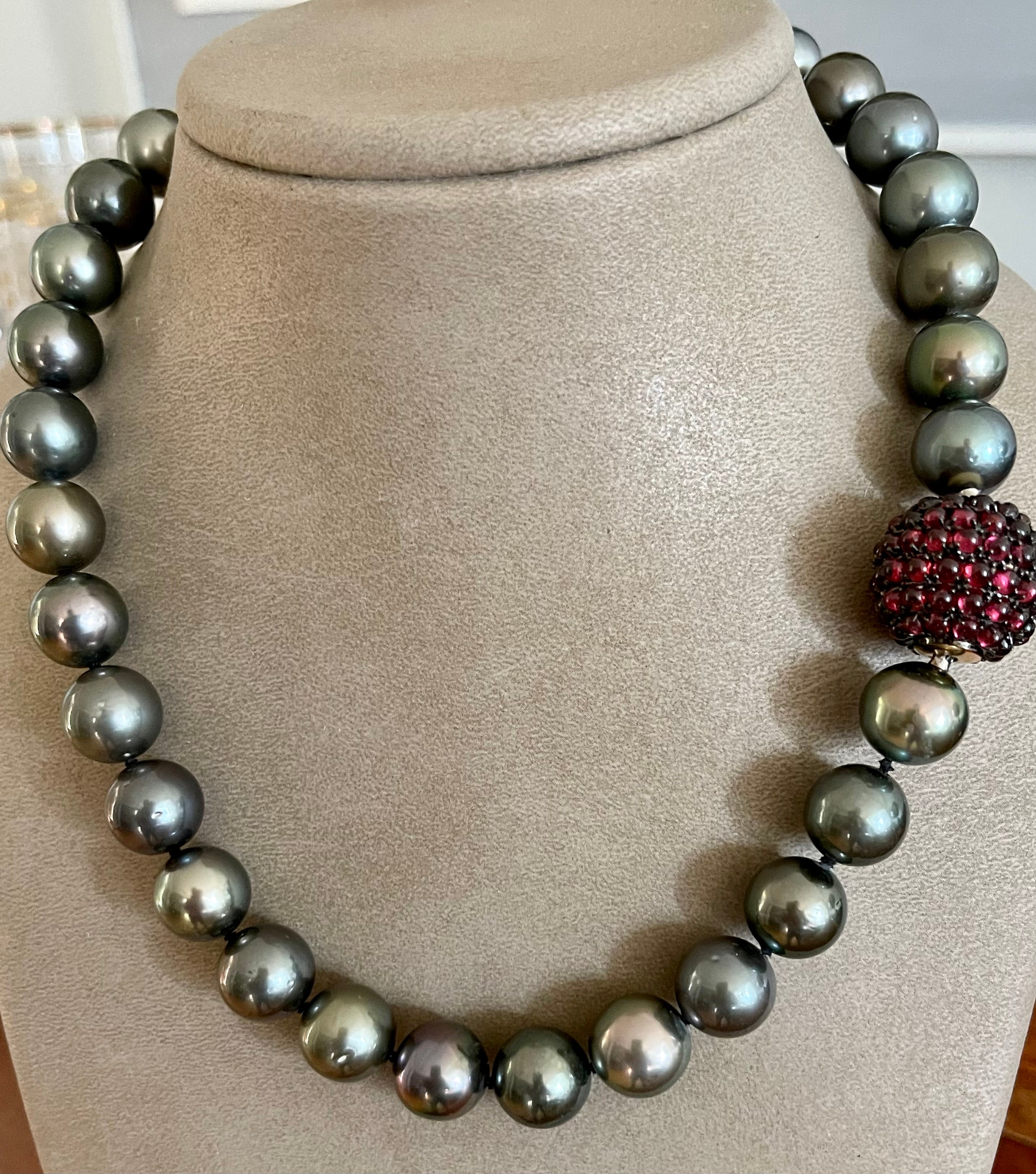 This strand of cultured Tahitian pearls consists of 33 round Pearls graduating from 12.5 mm - 13mm. The Body color of the pearls is a medium light gray with beautiful pink overtones. The pearls are of round to near round shapes, with a slightly