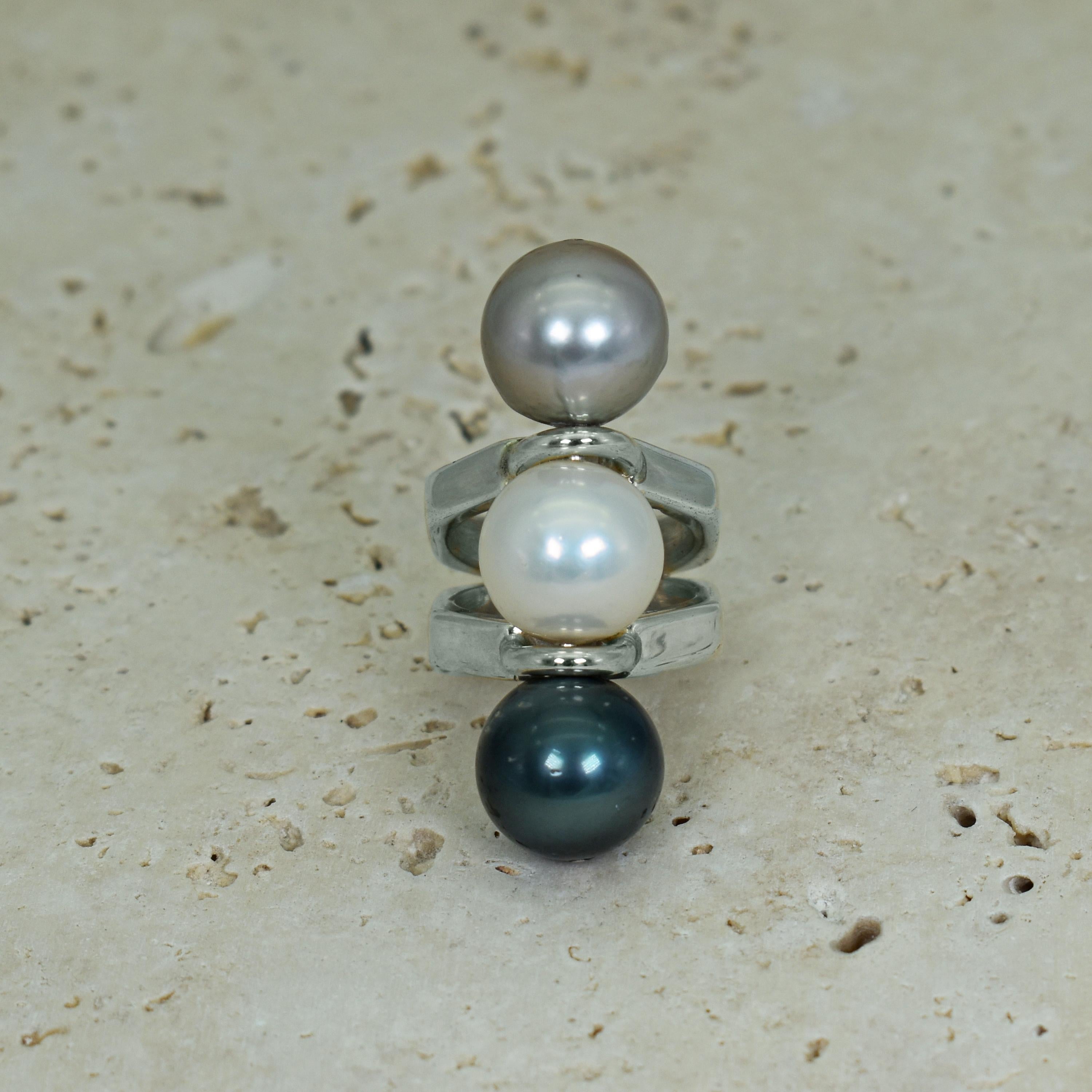 Three 14mm Pearls including Tahitian, white Freshwater and Dove gray Pearls with sterling silver octagon-shaped split shank ring band. Ring is size 6. The row of Pearls measures 1.75 inches in length. Stamped 925. Unique and contemporary setting