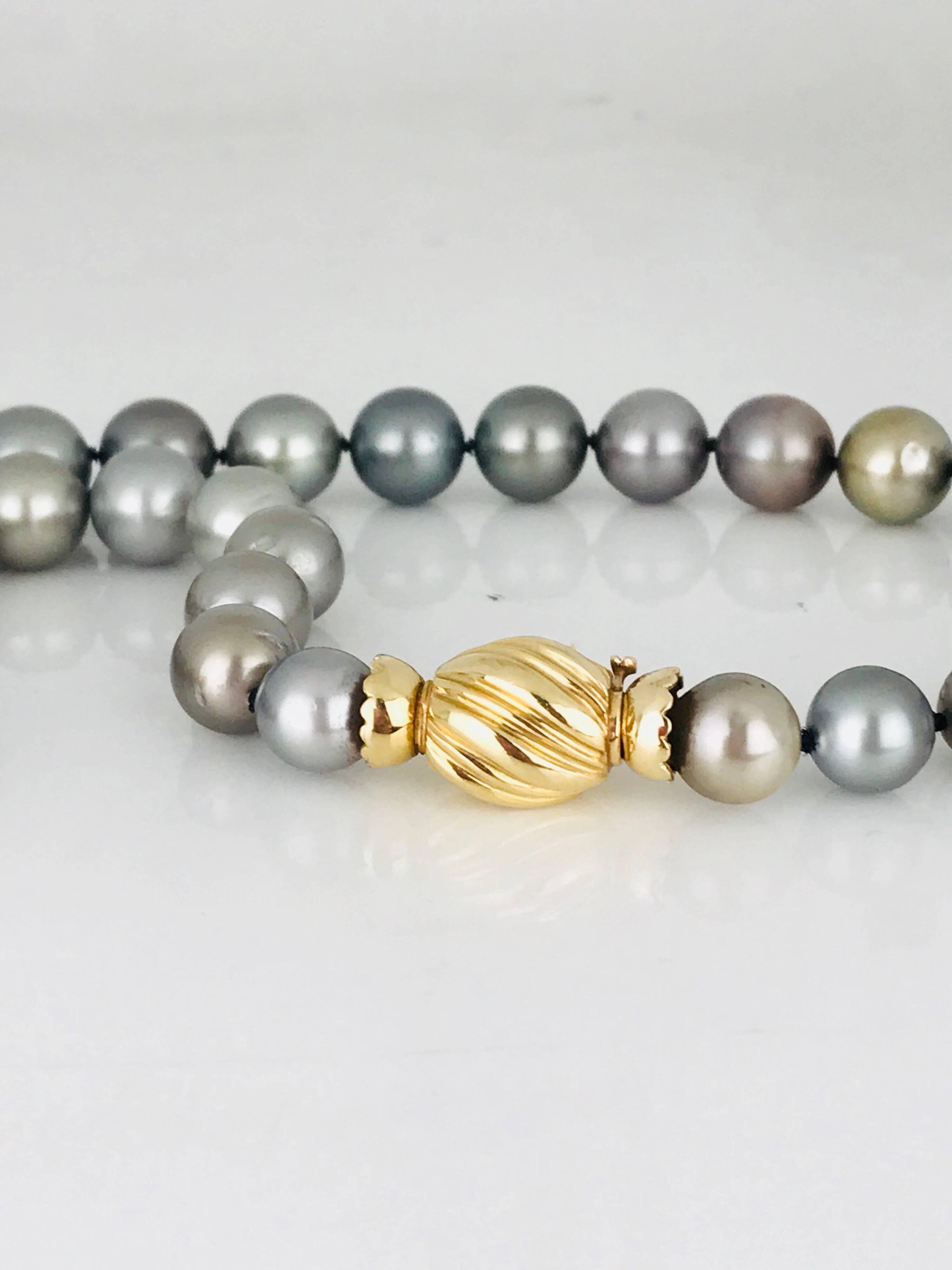 One strand of Tahitian Gray pearls measuring 7-1/4 inches in length. The pearls graduate from 11.66 millimeters to 9.15 millimeters, center. 

A total of 37 pearls are rounded with minor, imperfections. The color is gray with a slight variation, and