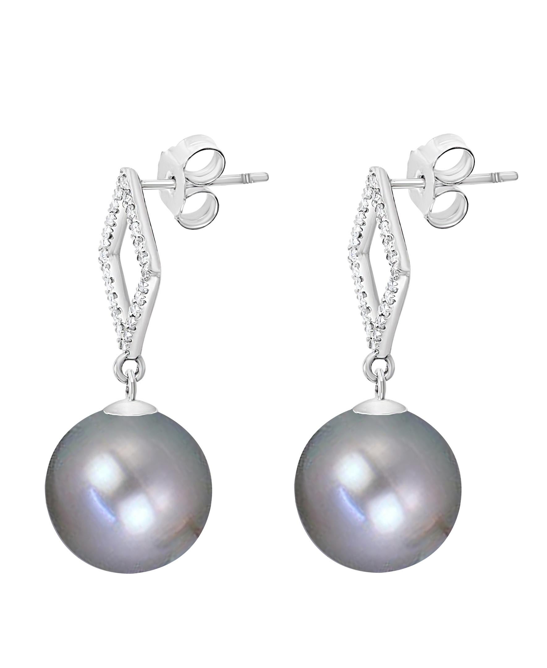 These elegant Diamond and Pearl earrings feature South Sea Tahitian Grey cultured pearls set tastefully on a diamond adorned white gold setting - an impeccable complement to any evening dress.
- 14K White Gold.
- 0.36 Carats of Diamonds. 
- Pearls