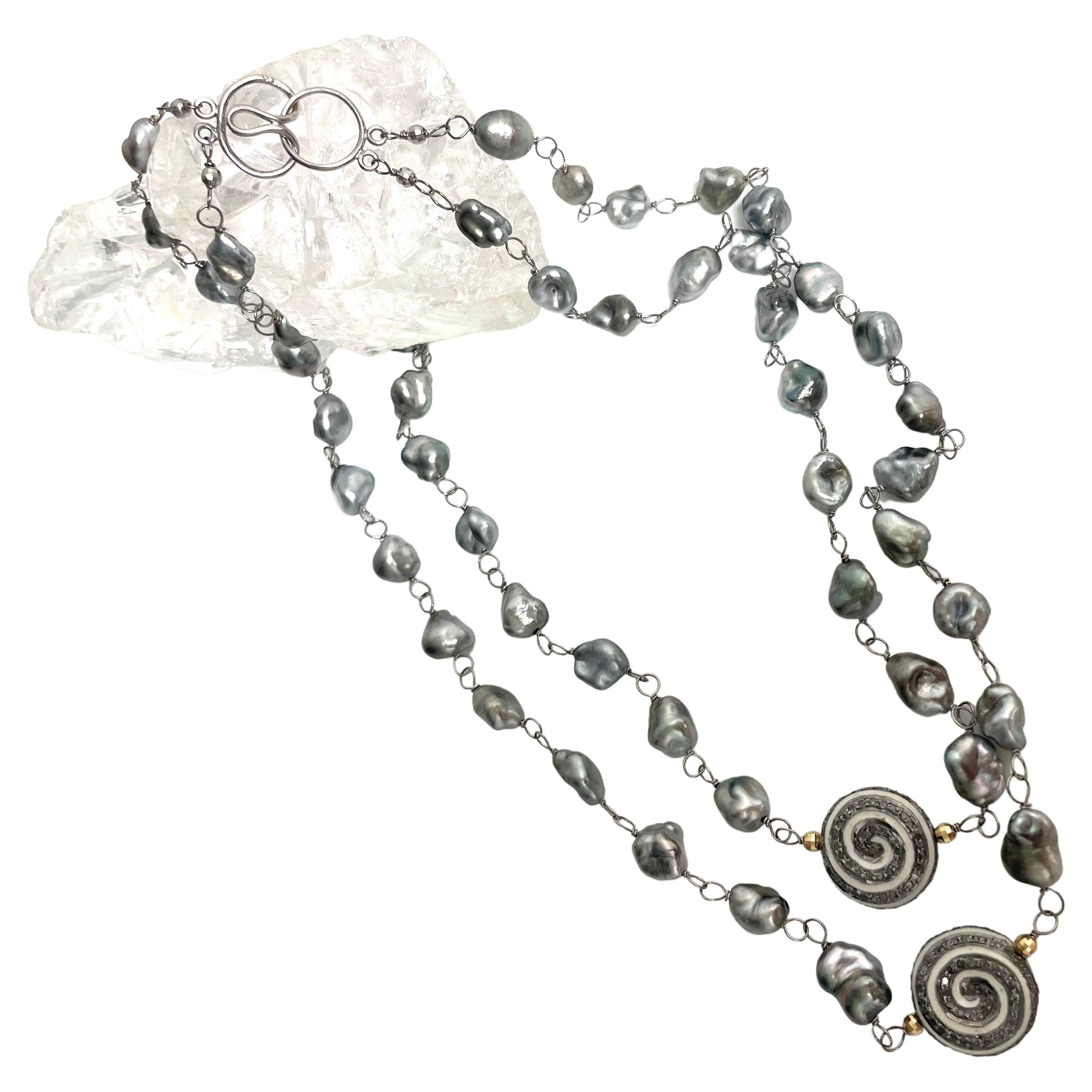 Description
Tahitian Keshi pearls with enamel and pave diamond pinwheels accented with 14k gold faceted balls, double strand necklace.
Item # N3714

Materials and Weight
Tahitian Keshi pearls, 8-9mm
Pave diamonds 2.12cts
Enamel
Faceted balls 3mm 14k