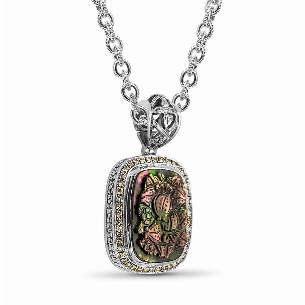 Step into a world of opulence and artistry with the Hand Carved Tahitian Mother of Pearl & 0.50cts Champagne Diamond Pendant in Sterling Silver by Stephen Dweck. This exquisite piece showcases the masterful craftsmanship of Stephen Dweck, featuring