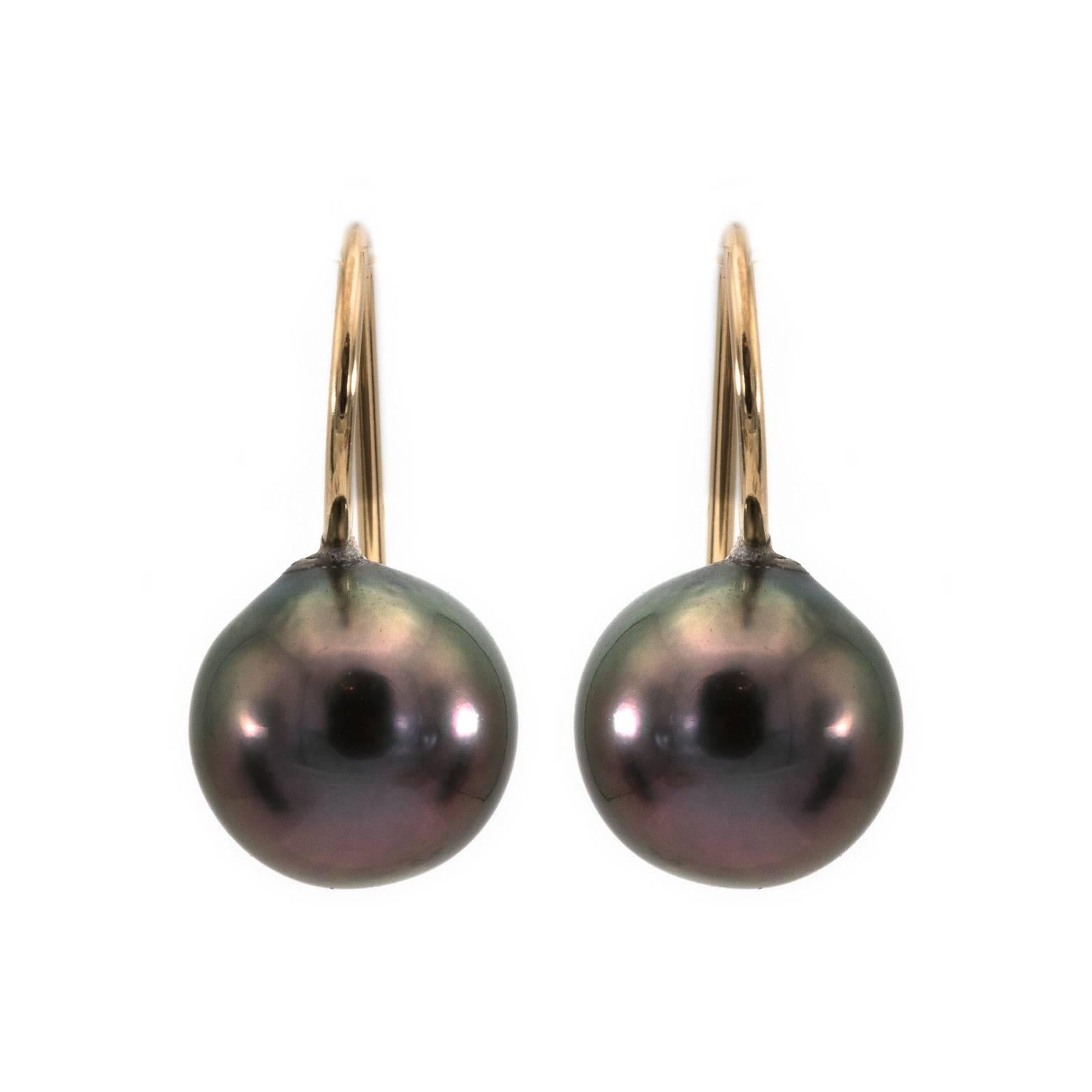 These stunning deep blue Tahitian pearl earrings are the perfect pair to wear every day. The 18k gold wire is looped around to anchor the pearl just a tad below the earlobe for the full vision of these beautifully matched pearls. You will love them!!