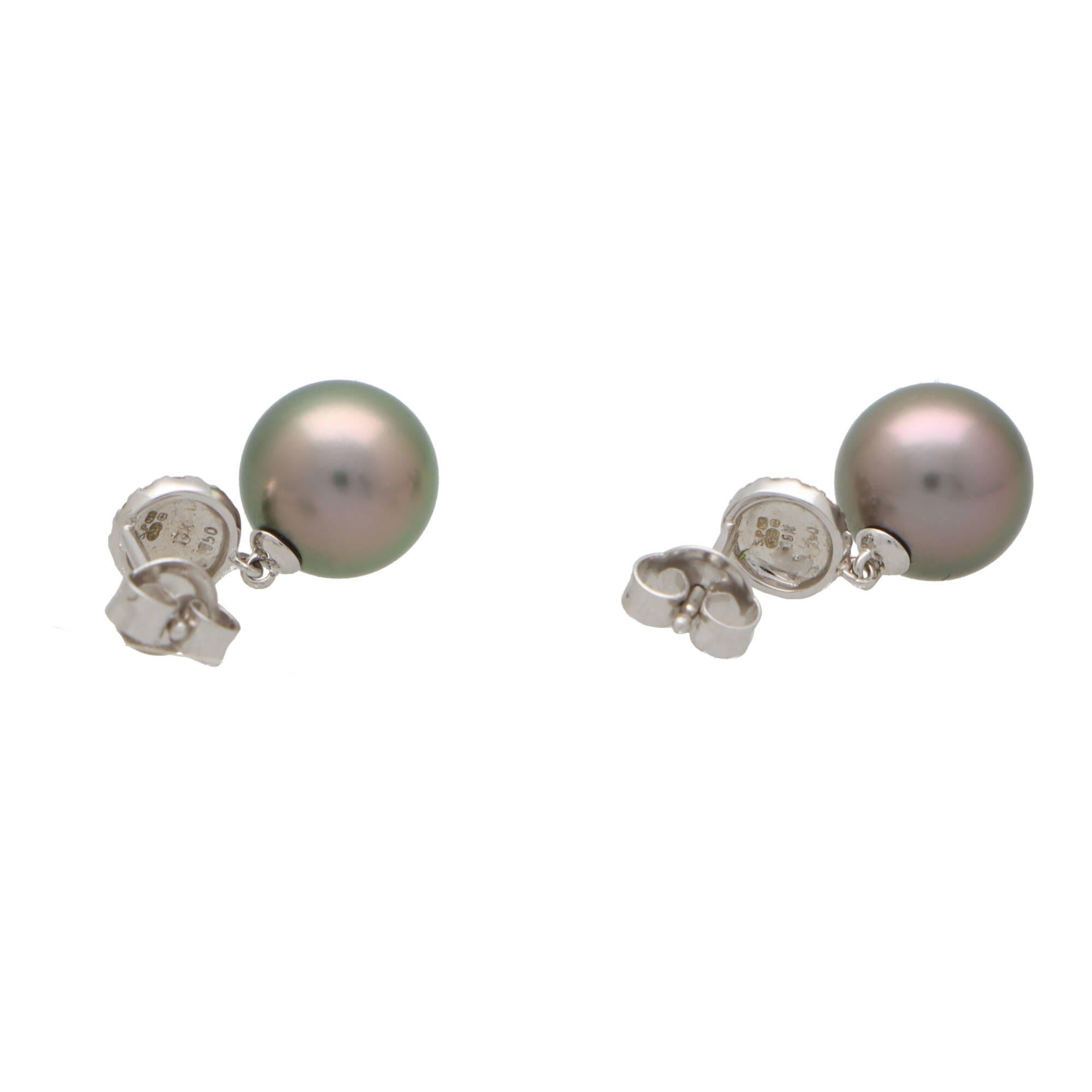  A beautiful pair of Tahitian pearl and diamond drop earrings set in 18k white gold.

Each earring is firstly composed of round white gold disc, entirely pave set with round brilliant cut diamonds. This creates a fantastic sparkle on the lobe! From