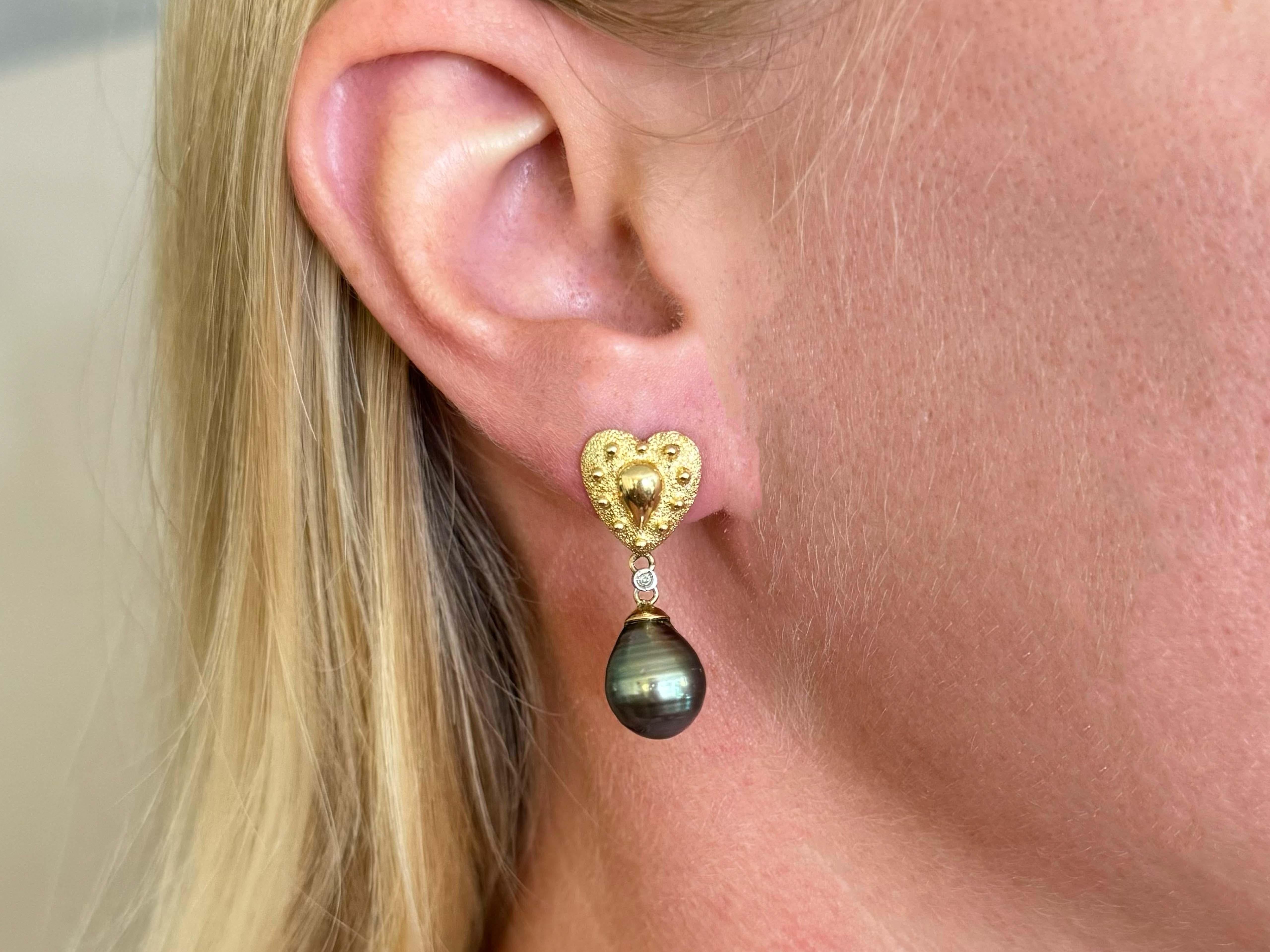 These stunning Tahitian pearls feature yellow, green and blue hues.

Earrings Specifications:

Metal: 14k Yellow Gold

Earring Length: 1.2