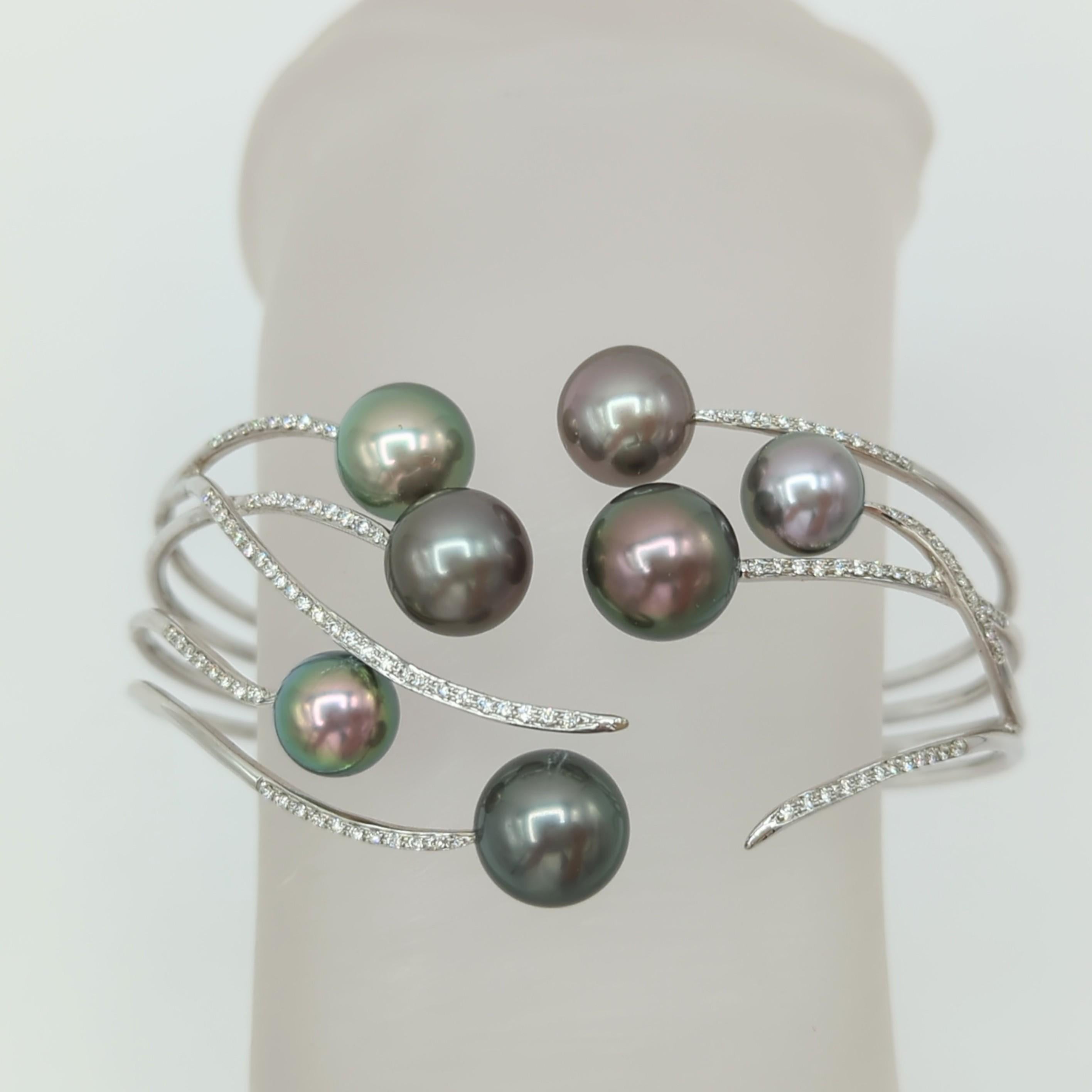 Beautiful Tahitian pearls with 0.50 ct. good quality white diamond rounds.  Handmade in 18k white gold.
