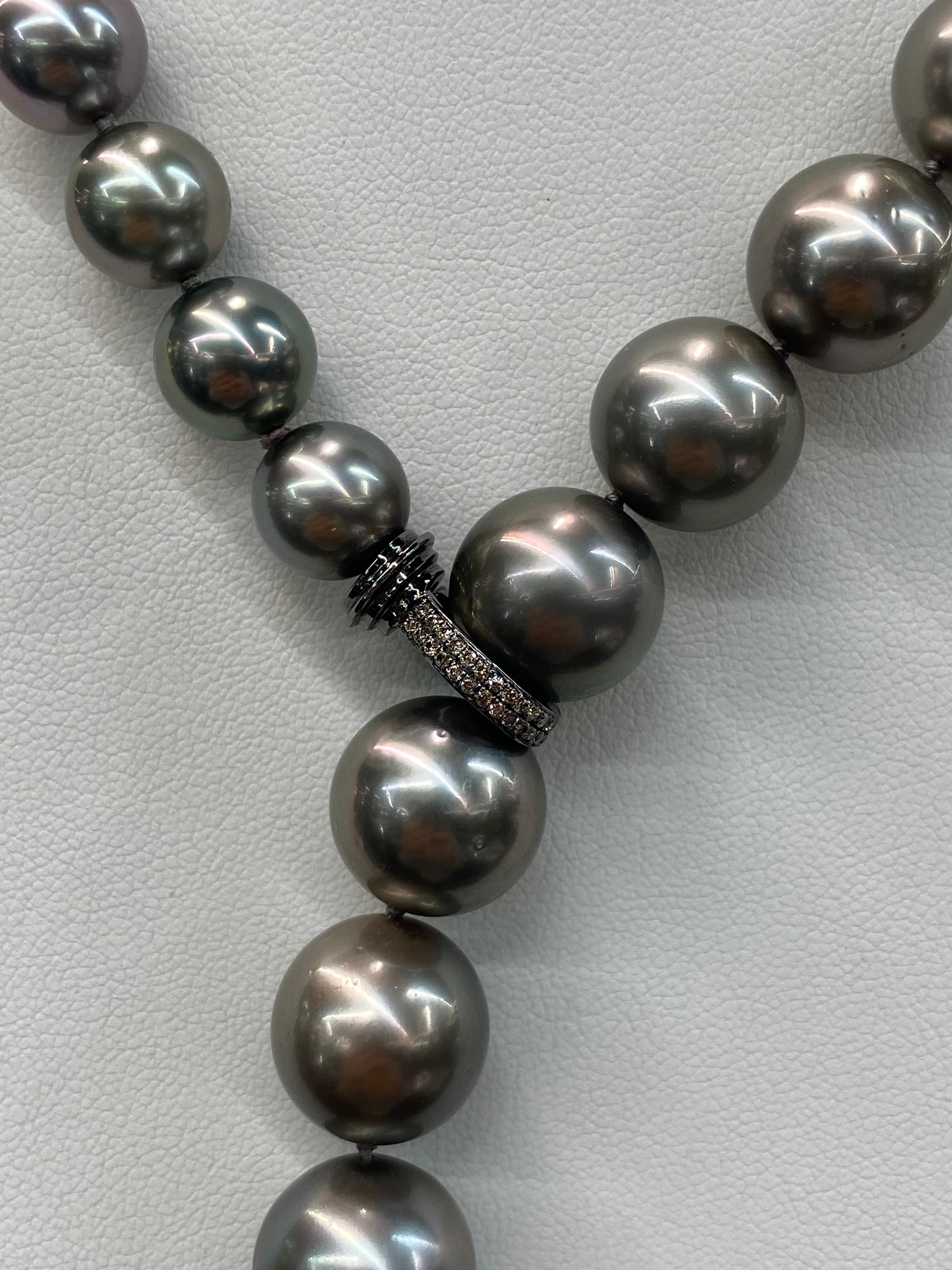 Chic Tahitian Pearl necklace featuring 47 pearls measuring 9.9-14 mm and a diamond front clasp. 
Pearl quality: AAA
Pearl Luster: AAA Excellent
Nacre : Very Thick

Strand can be made to order, shortened or longer. Clasp can be changed, Diamond