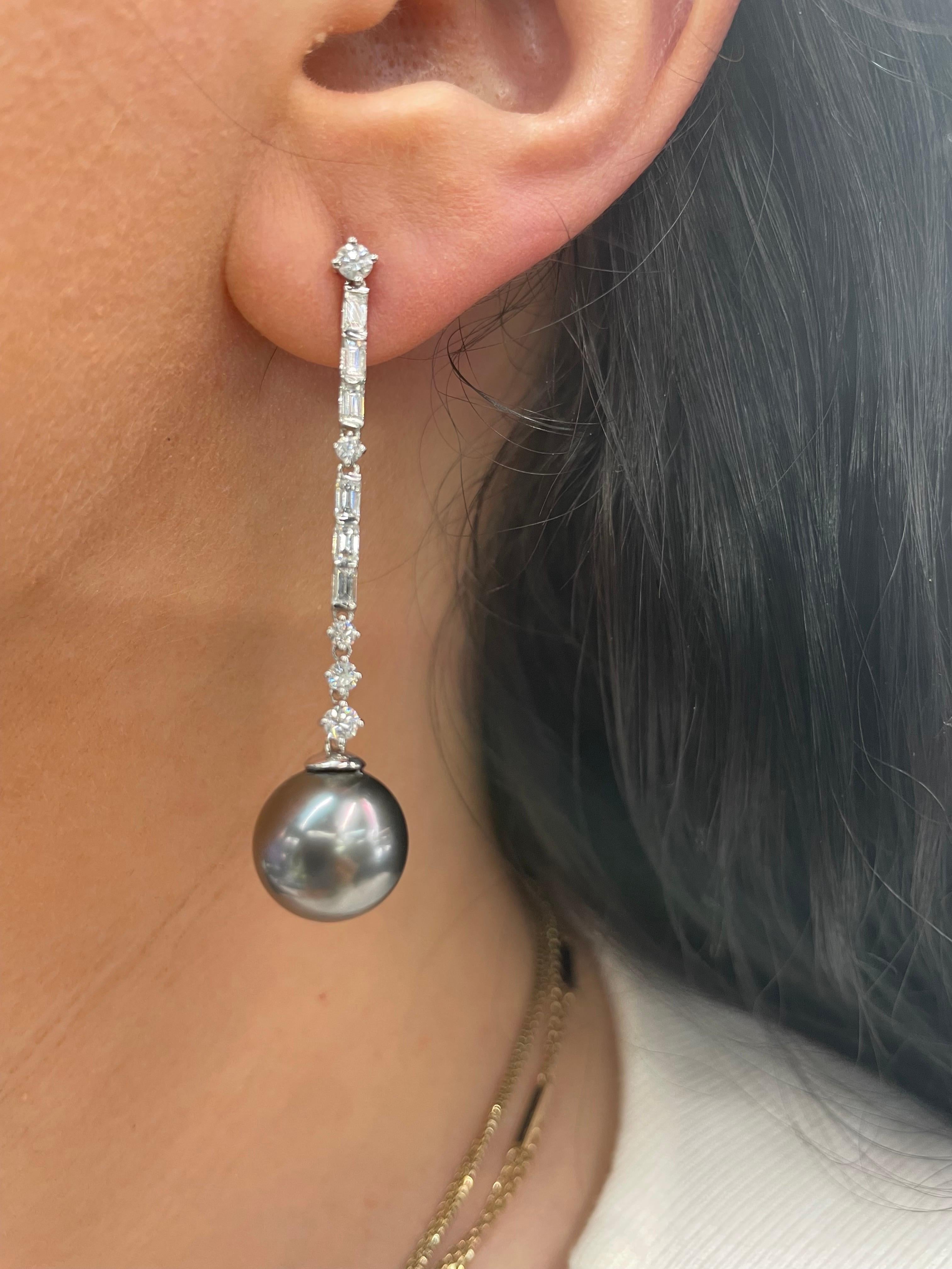 18 Karat White gold drop earrings featuring two Tahitian Pearls measuring 12-13 MM and 12 baguettes, 0.78 carats, and 10 round brilliants weighing 0.59 carats.
Pearls can be changed to South Sea, Pink Freshwater or Golden. 
DM for more information. 