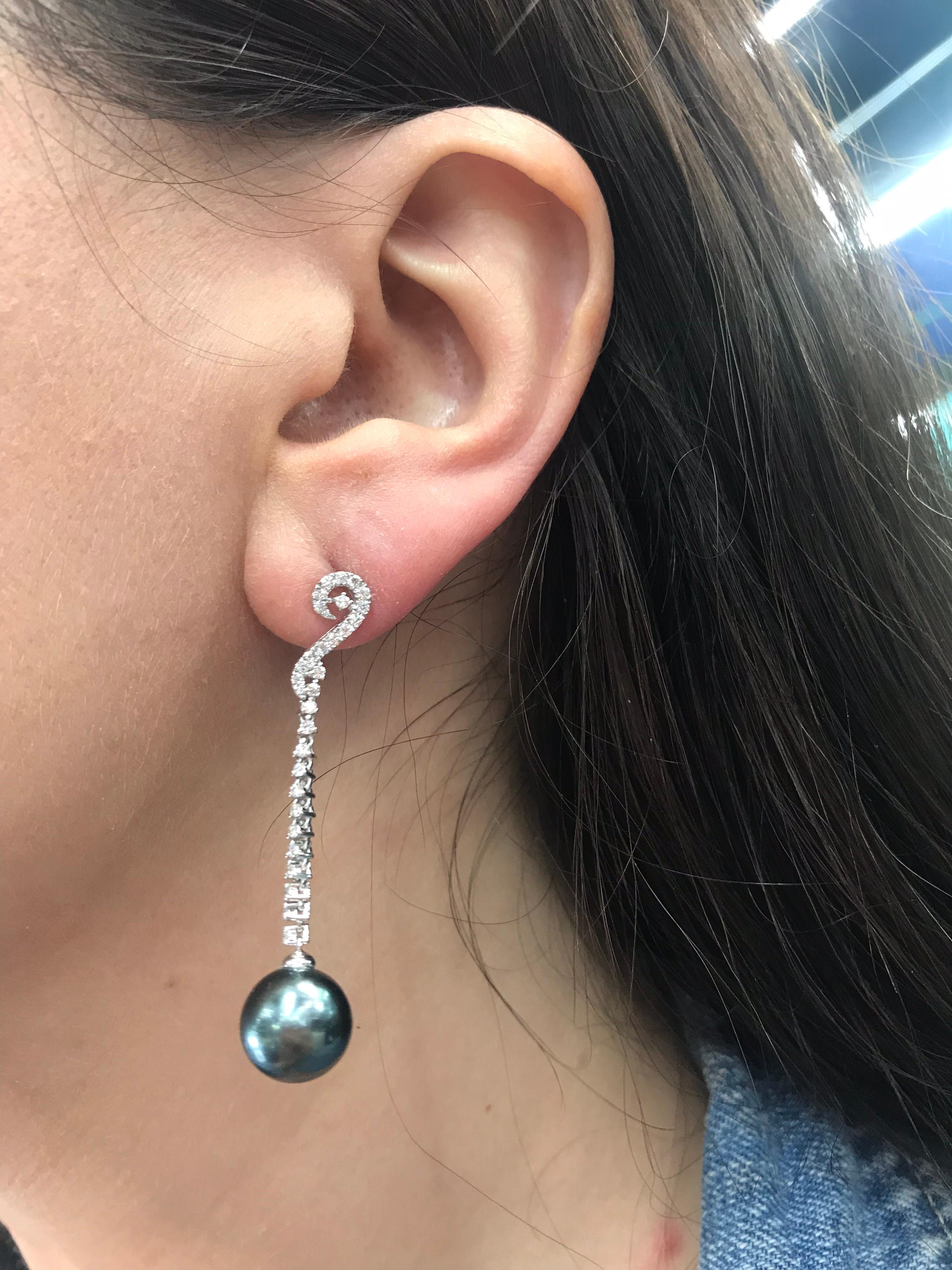 18K White gold drop earrings featuring 62 round brilliants weighing 0.52 carats and two Tahitian pearls measuring 10-11 mm. 
