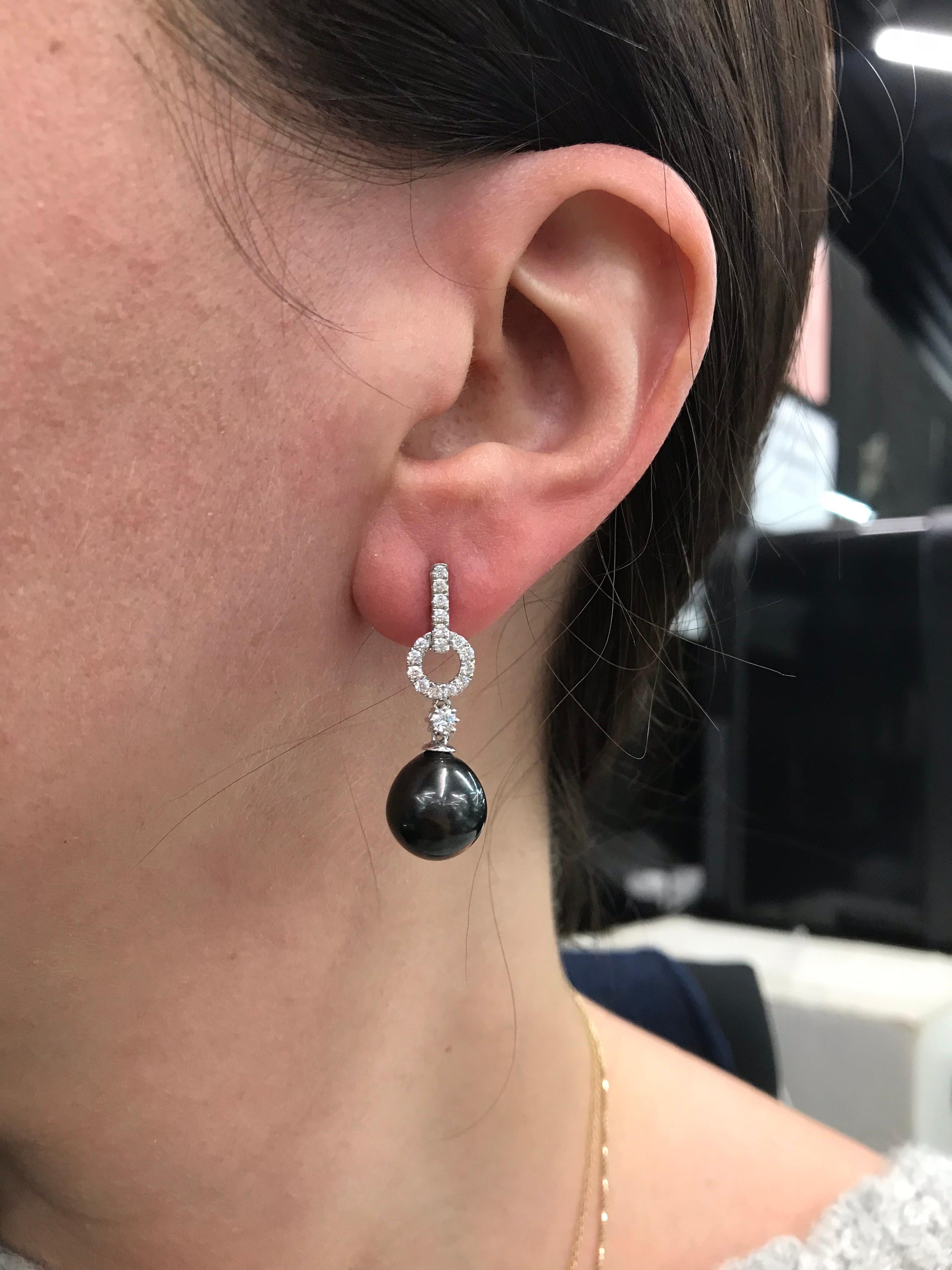 18K White gold drop earrings featuring 32 round brilliants weighing 0.42 carats, two round brilliants drops weighing 0.13 carats and Tahitian pearls measuring 11-12 mm.
Color G-H
Clarity SI

Available in Yellow Gold and can customize to South Sea,