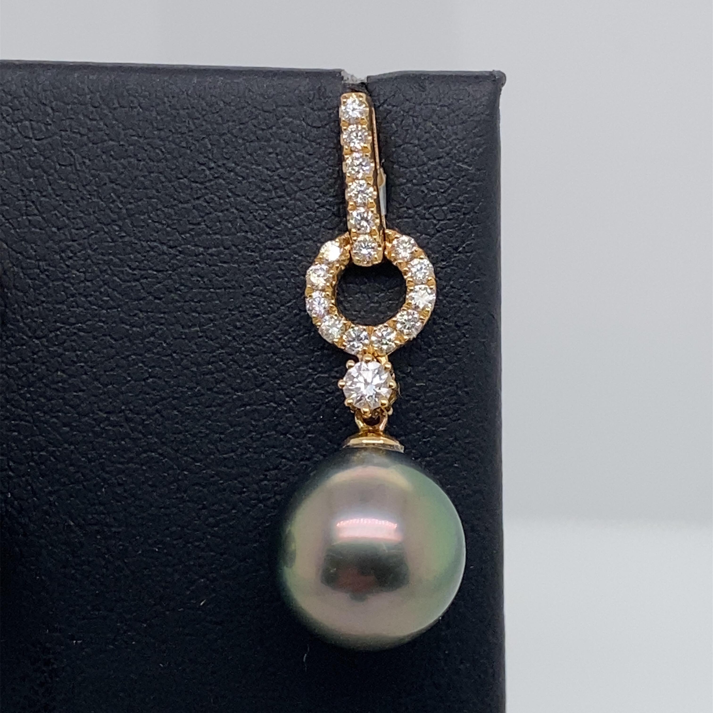 18K Yellow gold drop earrings featuring two Tahitian pearls measuring 11-12 mm flanked with 34 round brilliants weighing 0.61 carats. 
Color G-H
Clarity SI

Available in White Gold
Pearls can be changed to South Sea, Gold or Pink Freshwater
DM for
