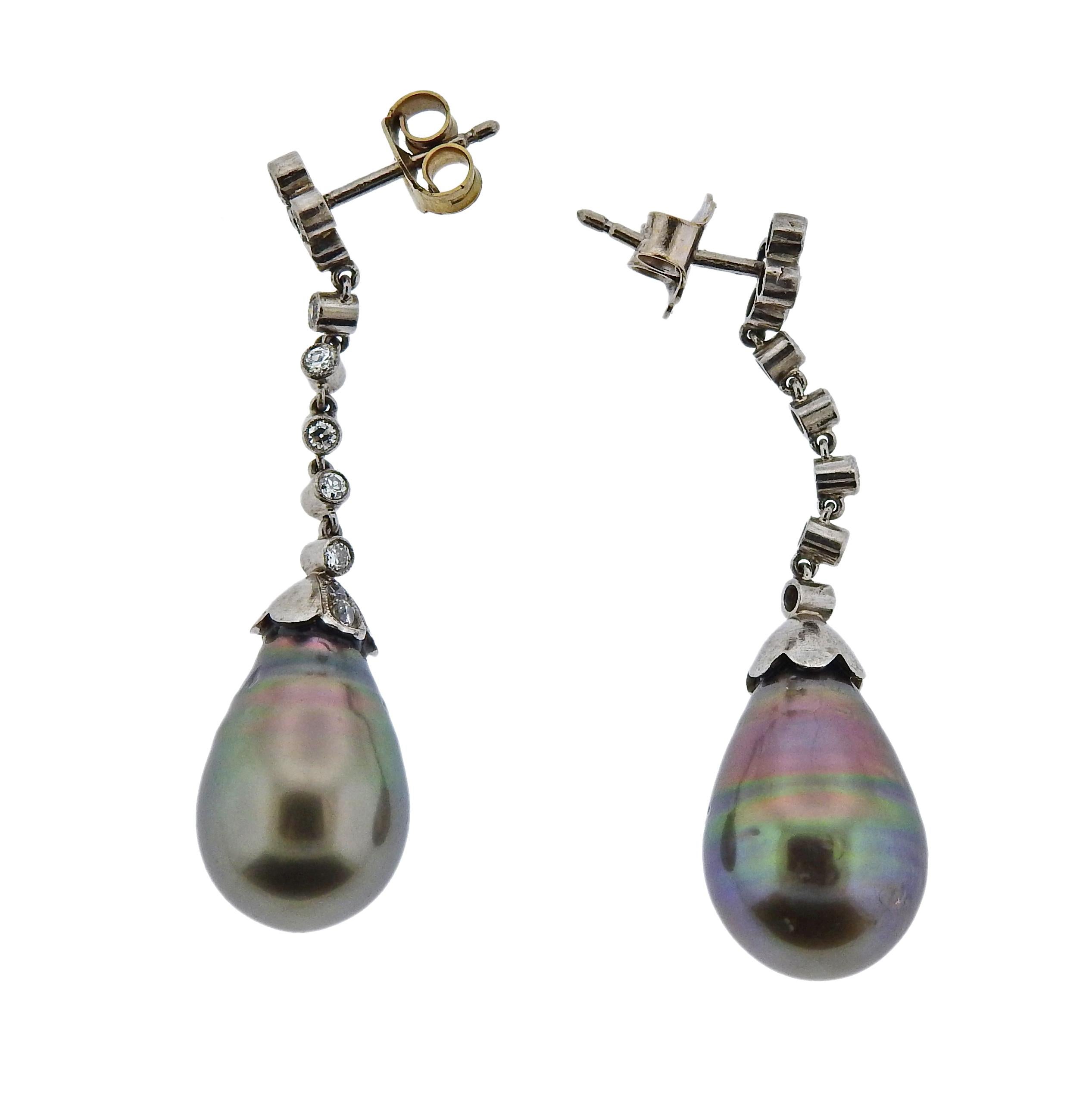 Pair of 18k gold drop earrings, featuring 11mm x 16.5mm Tahitian pearls and approx. 0.50ctw in diamonds.  Marked 18ct on the posts. Earrings are 43mm long. Weigh 8.8 grams.

SKU#E-02742