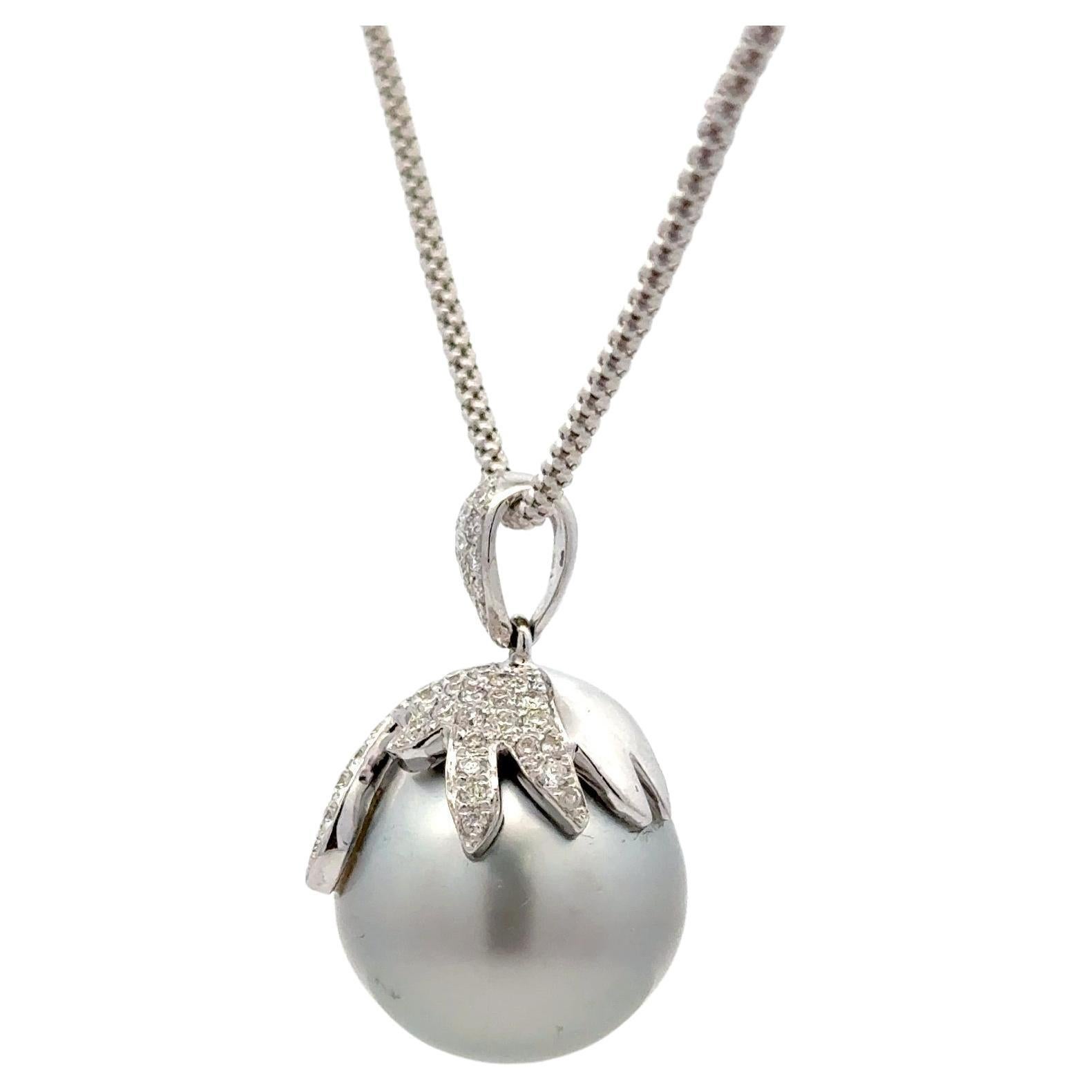 18 Karat white gold pendant featuring one light grey Tahitian Pearl measuring 15 mm with a diamond cap of 86 round brilliants weighing 0.83 carats. 

Diamond Bale 8.4 MM Long
Diamond Cap with Pearl measures 18.9 MM Long
Pedant total 27.3 MM
