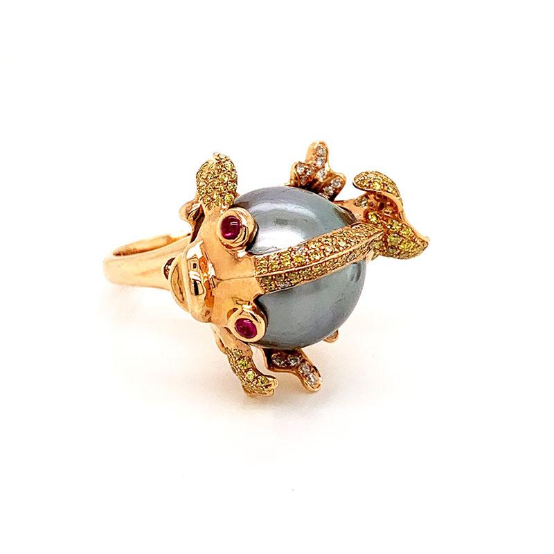 The sweetest fish in the sea! A tahitian pearl makes the body of this cute little critter which is set in 18k rose gold. There are 0.89 carats of fancy yellow diamonds which are set on the fins and tail of the fish. Two rubies are used for the eyes.