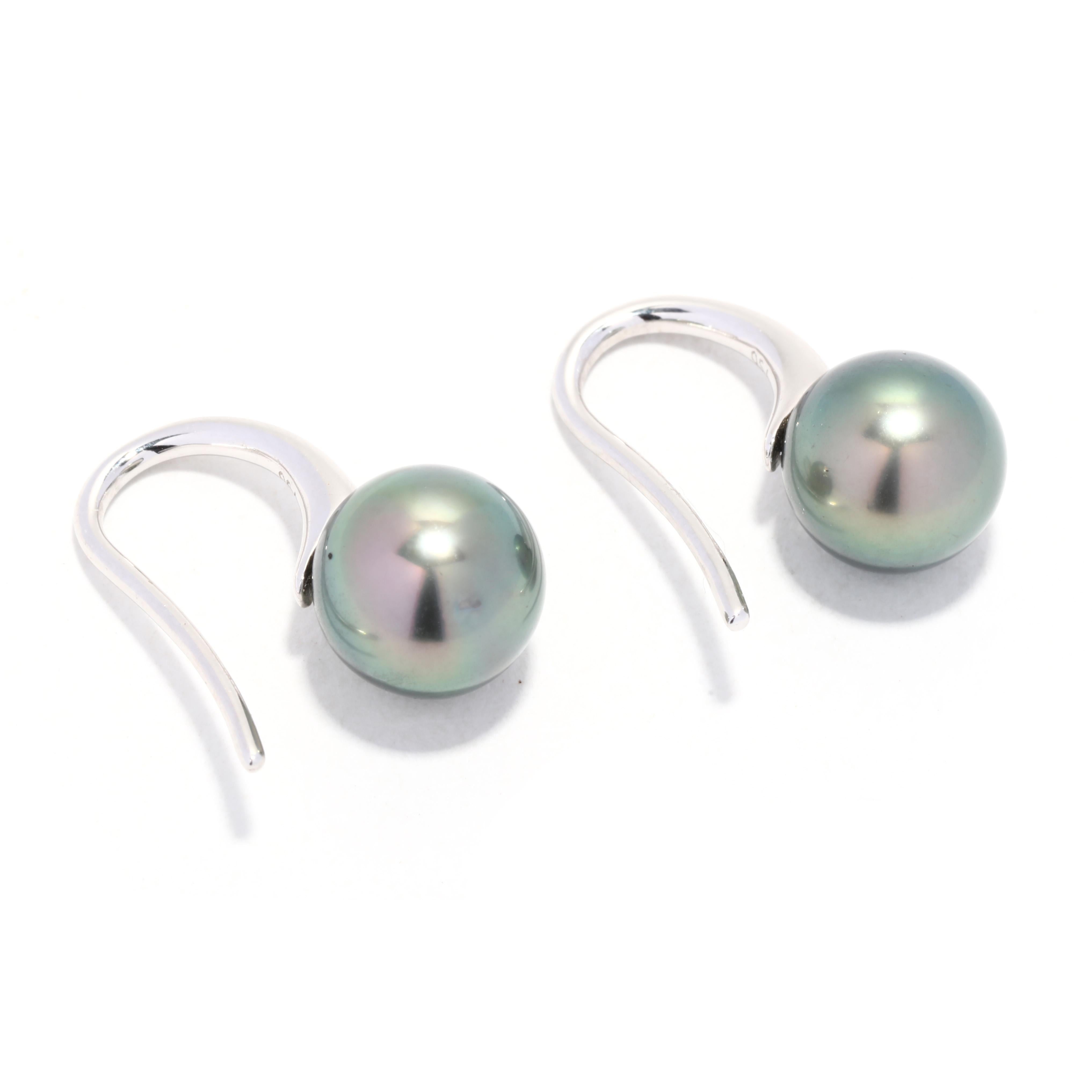 A pair of 18 karat white gold Tahitian pearl drop earrings. This simple pearl drops feature 9.4 mm black Tahitian pearls, dropped from a thin tapered ear wire.

Stones:
- Tahitian pearl, 2 stones
- round bead
- 9.4 mm

Length: 5/8 in.

Width: 9.4