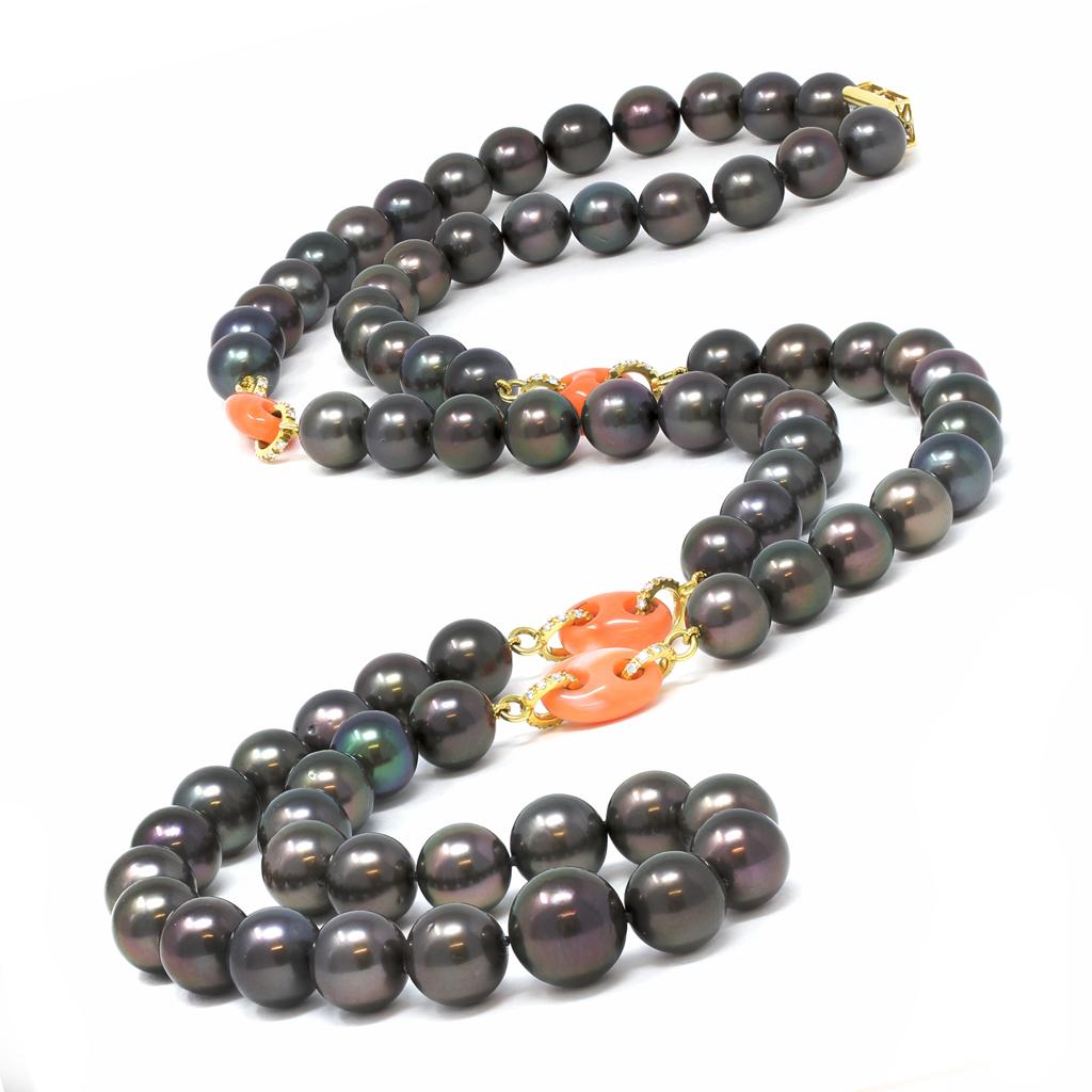 18 karat yellow gold, Tahitian black pearl, natural coral, and diamond necklace, the single-strand is composed of numerous Tahitian black pearls measuring 10.0 to 14.0 millimeters, spaced by carved coral links accented by round diamonds weighing