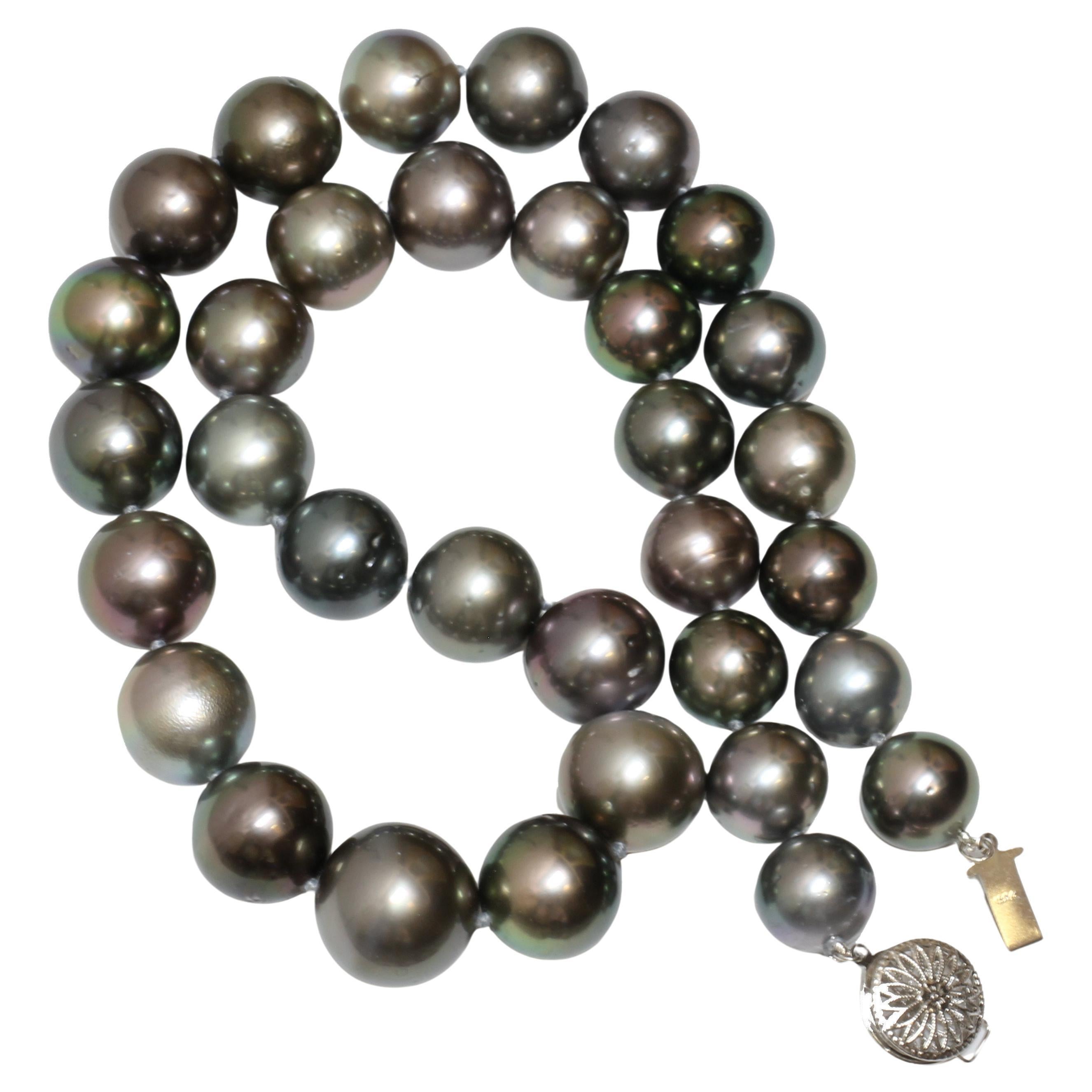 This stunning 16.5 - 12mm mm Tahitian pearl necklace features lustrous pearls with a captivating play of colors. The round and near-round pearls exhibit an array of grey, blue, and green overtones, creating a unique and elegant look. With a total